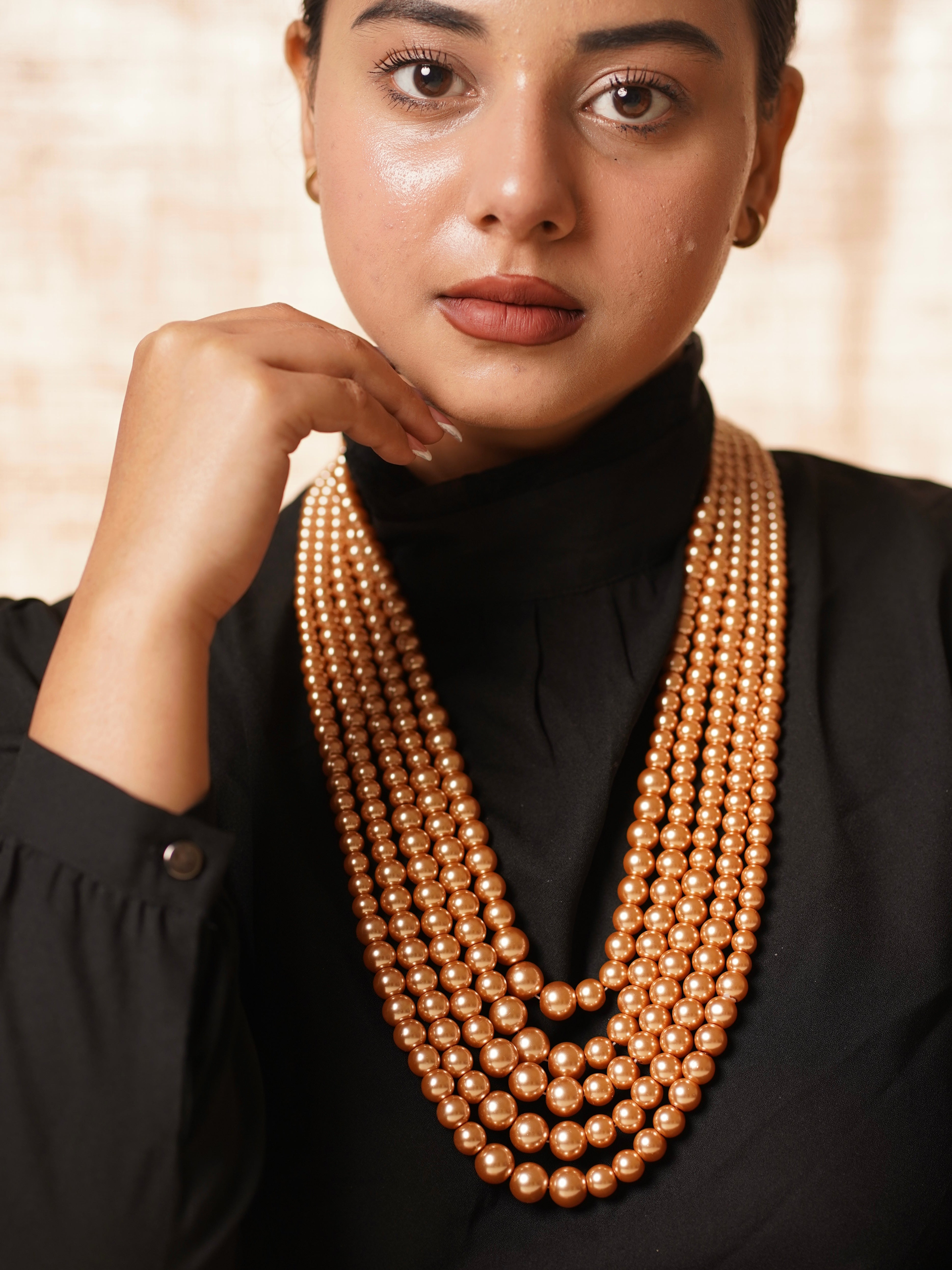 Side angle of multi-strand pearl necklace with antique-style clasp