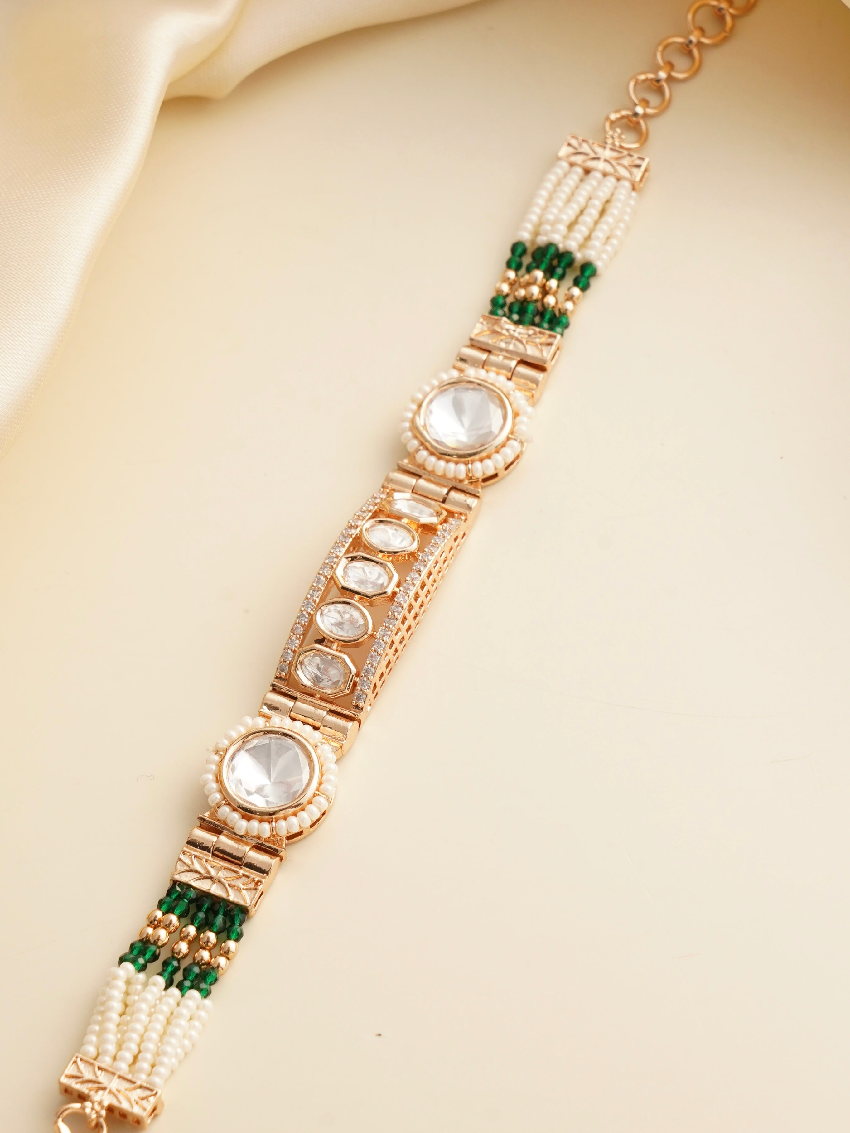 Close-up of pearl rakhi bracelet with intricate kundan centre design