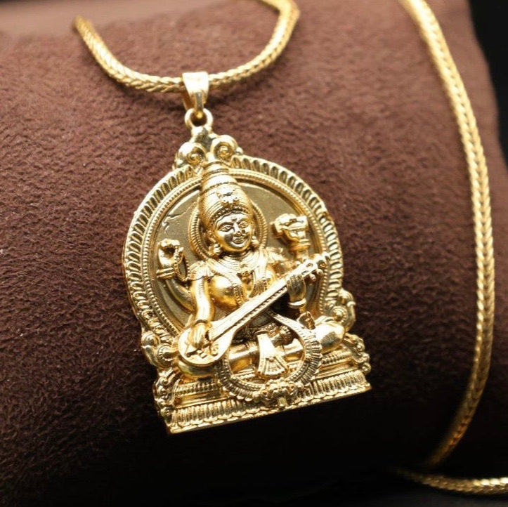Temple-style gold pendant with embossed deity design and antique finish