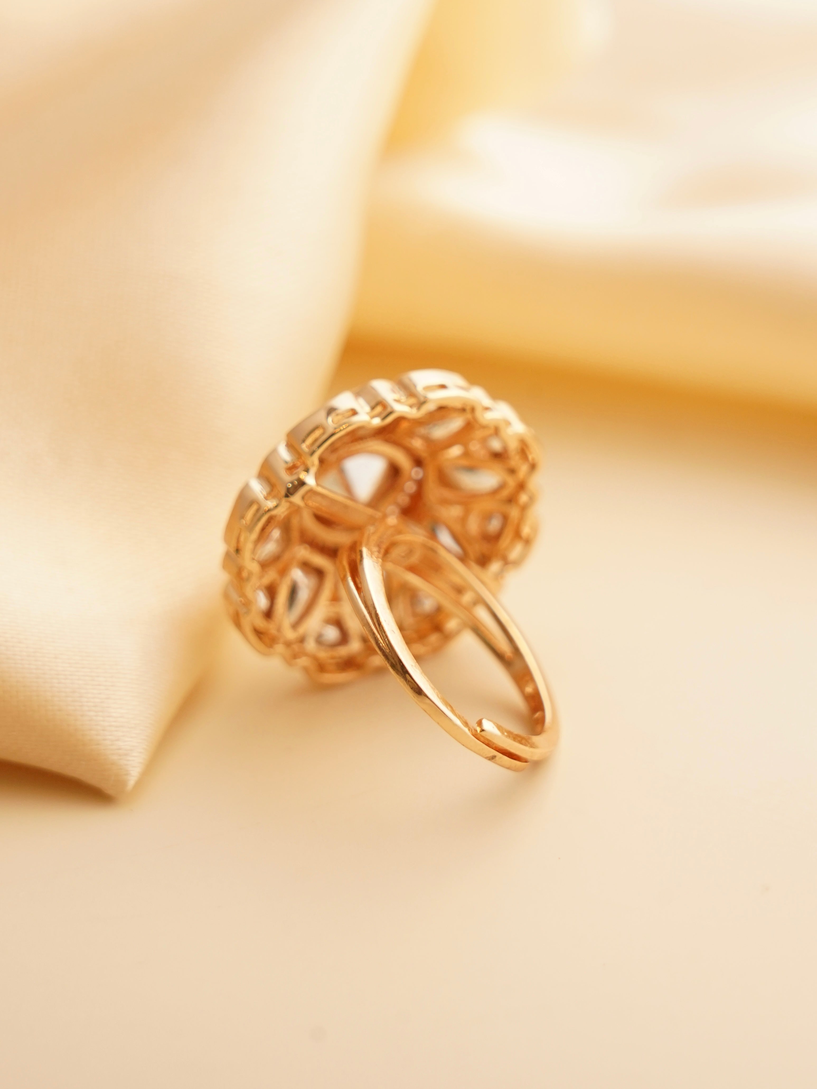 Angled shot of oversized kundan ring with radiant floral setting