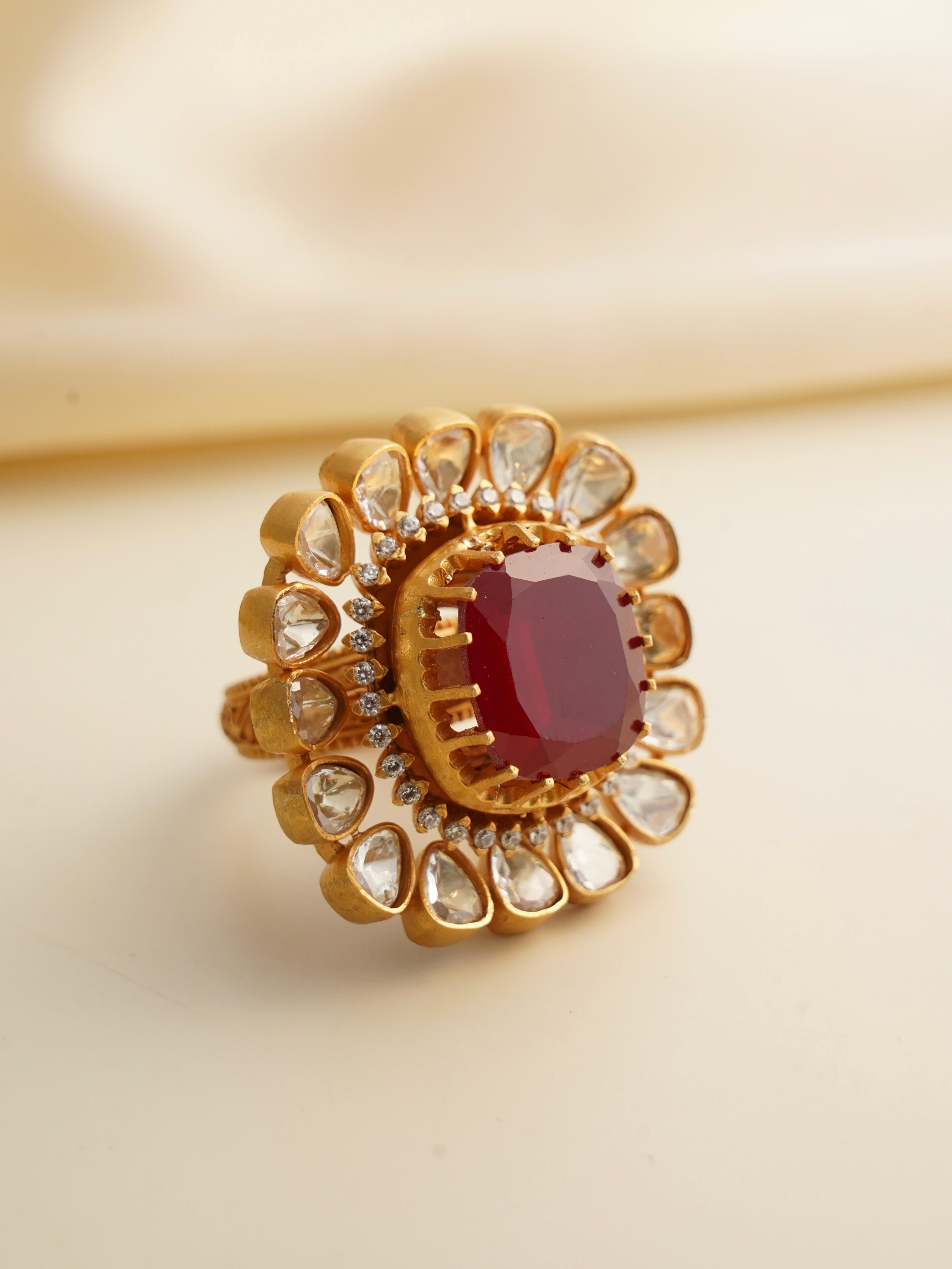 Top view of floral moissanite ring with large centre stone and uncut diamond simulants