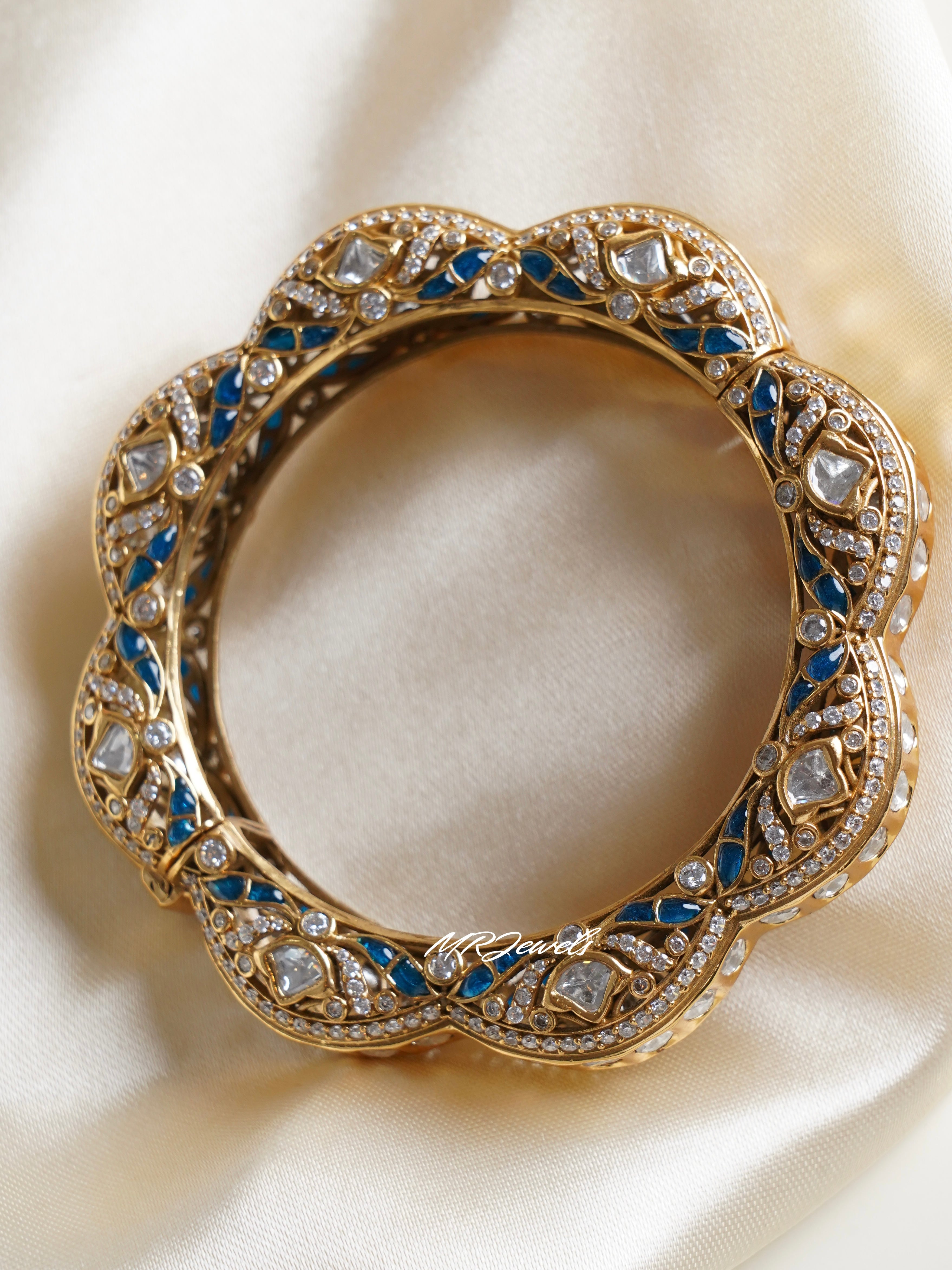 Gold-finished polki kadas with designer kundan work in front view