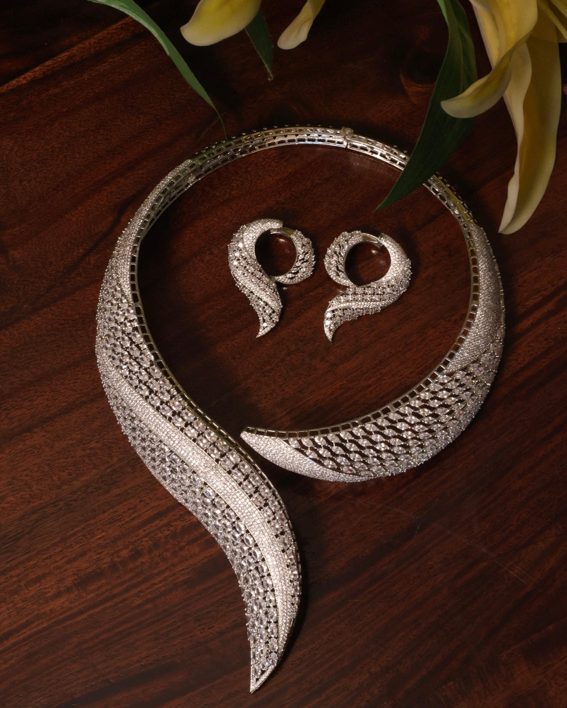 Side view of collar necklace highlighting diamond detailing and curved form