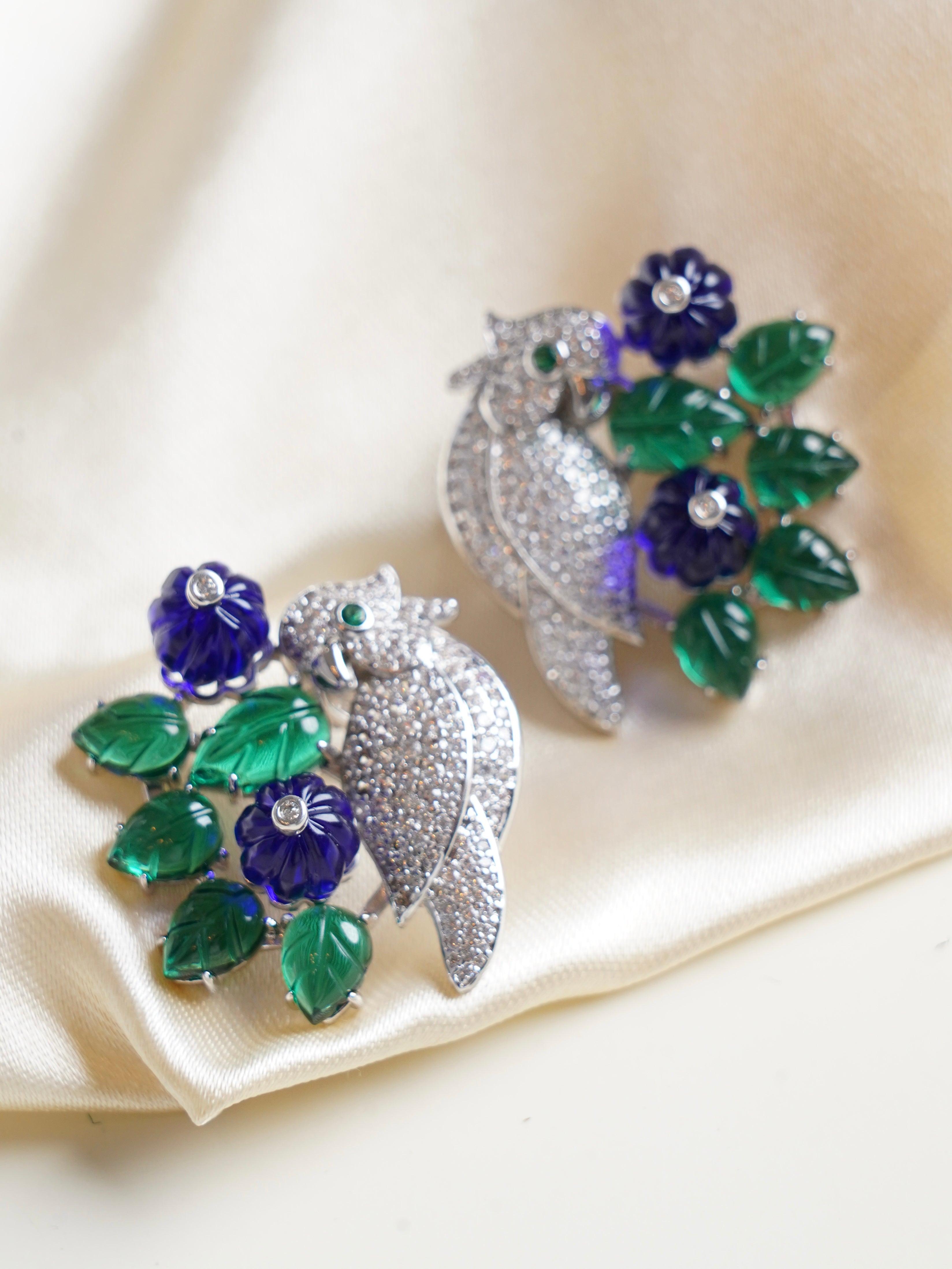 Nocturne Bloom earrings with pavé birds perched among carved emerald green leaves and violet flowers