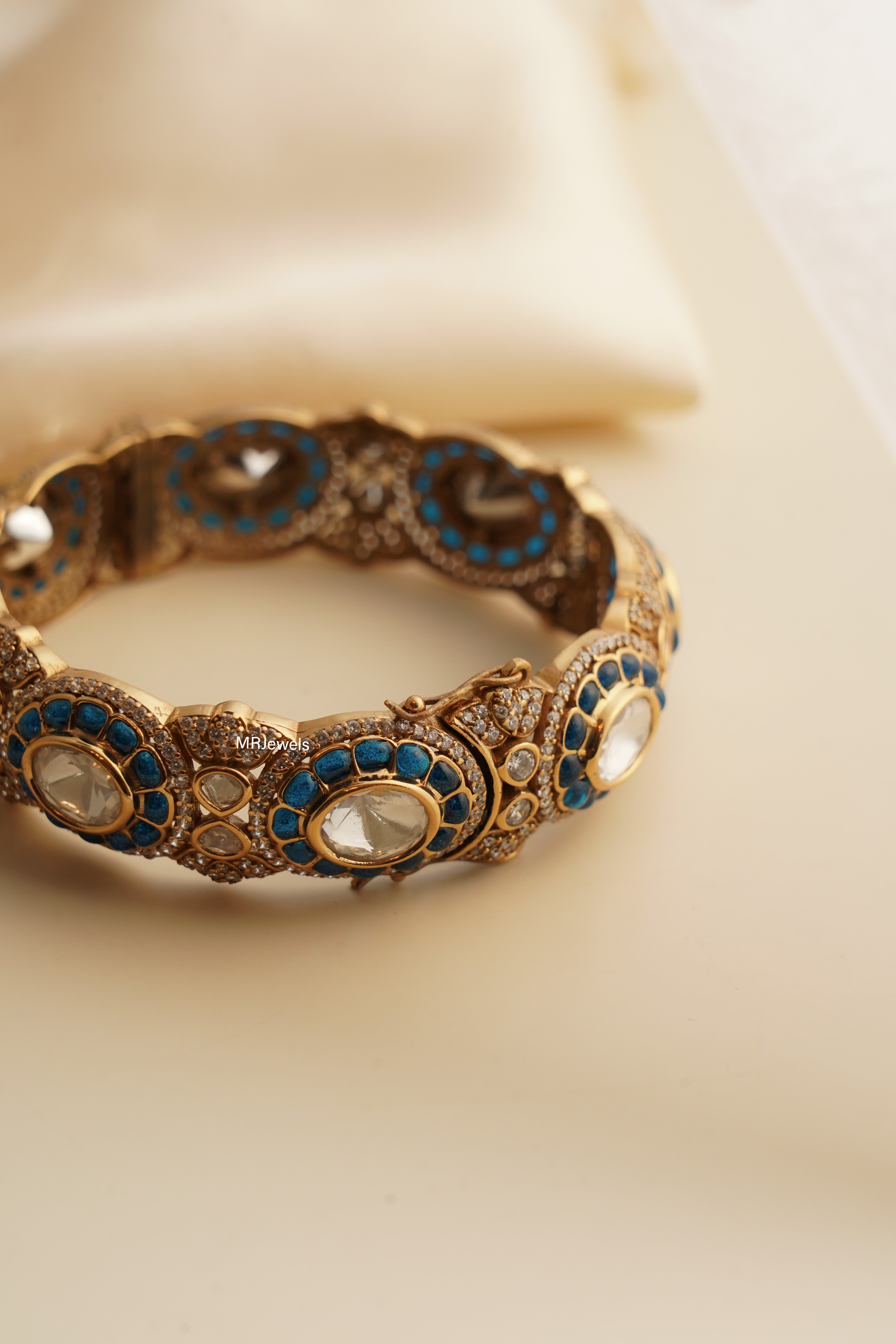 Side view of ruby bangle showing lustrous red stones set in classic gold finish