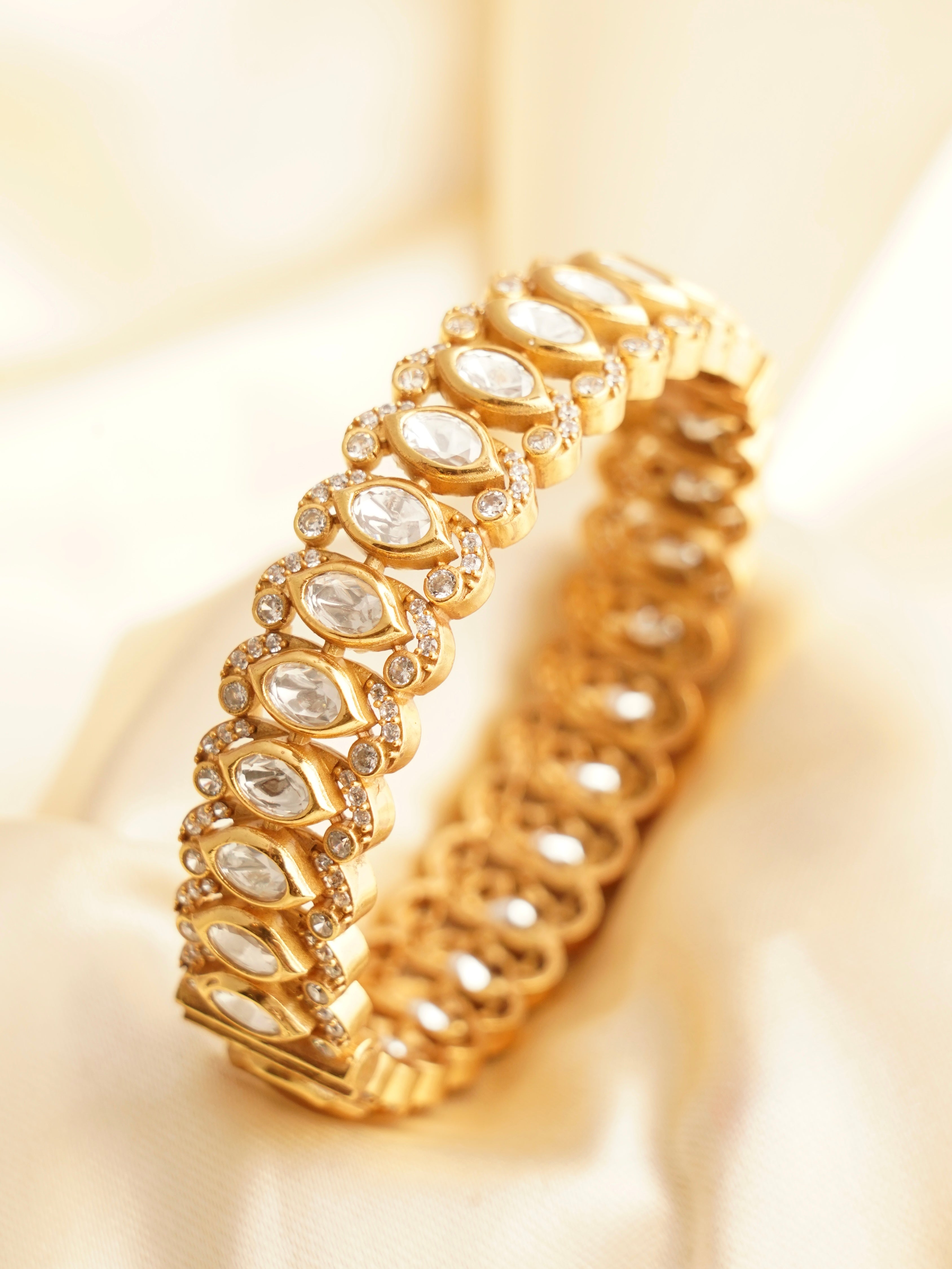 Gold-plated kada with oval kundan stones and openable clasp in traditional style
