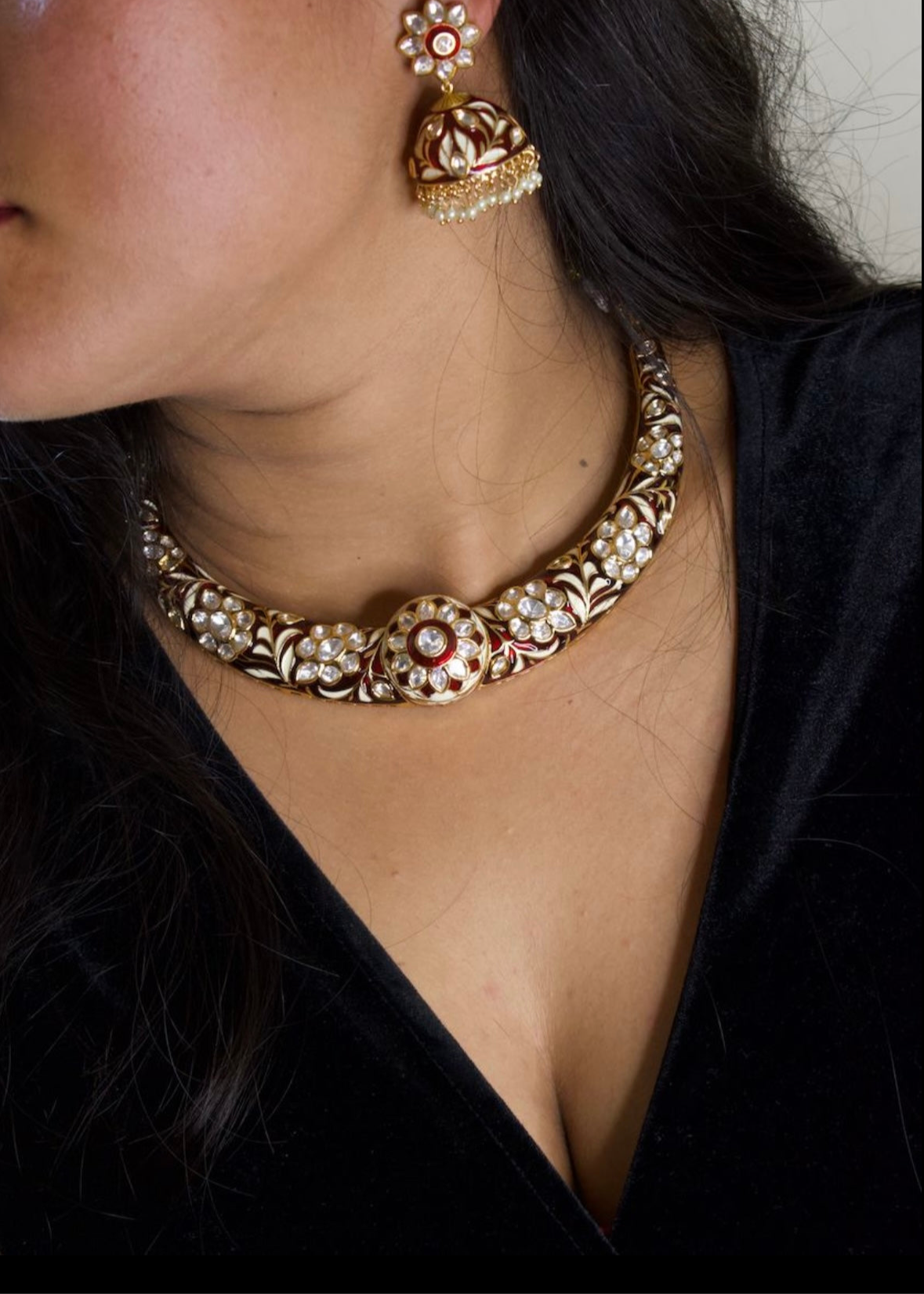 Side angle of hasli necklace set featuring detailed enamel and dangling jhumki