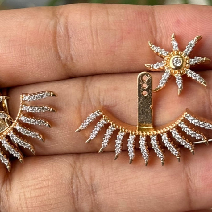 Close-up of cosmic-inspired starburst earrings with bold wrap design