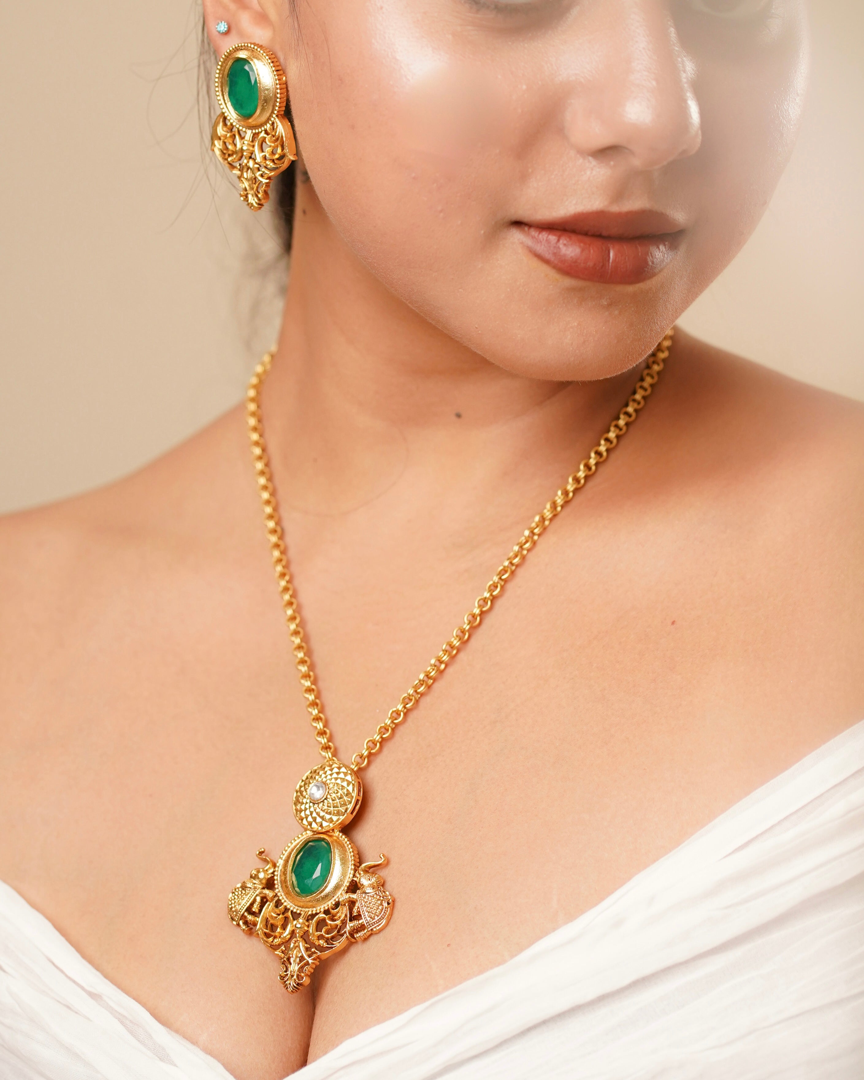 Amrapali-style necklace with pendant and earrings featuring emerald stone and intricate polish