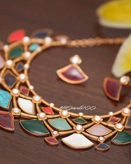 Close-up of mosaic necklace with designer cut stones and gold accents
