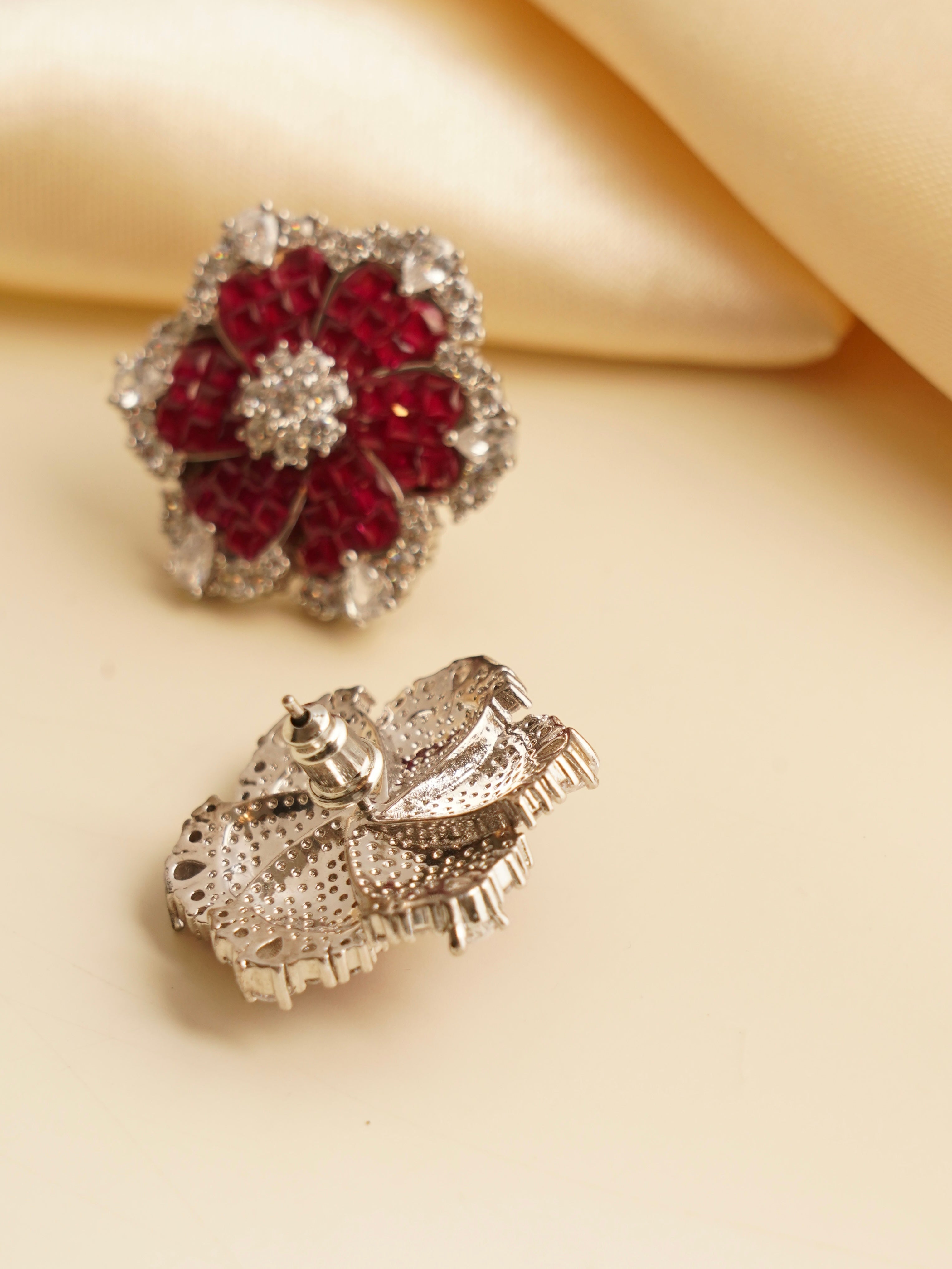 Side view of luxe emerald earrings with intricate gemstone setting