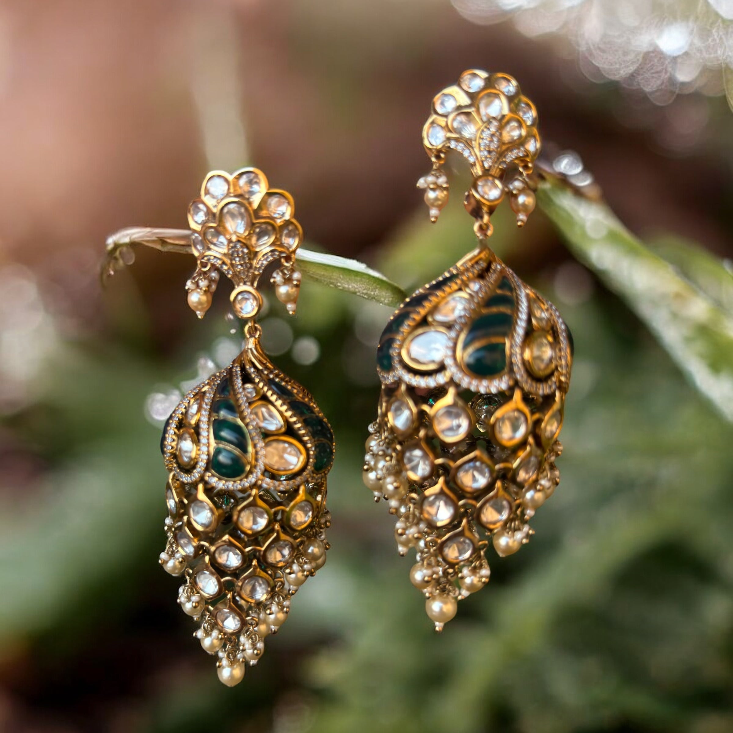 angled shot of rani chandrika kundan jhumkas with traditional ruby accents