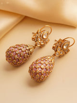 top view of gold-polished earrings with polki stones in teardrop shape