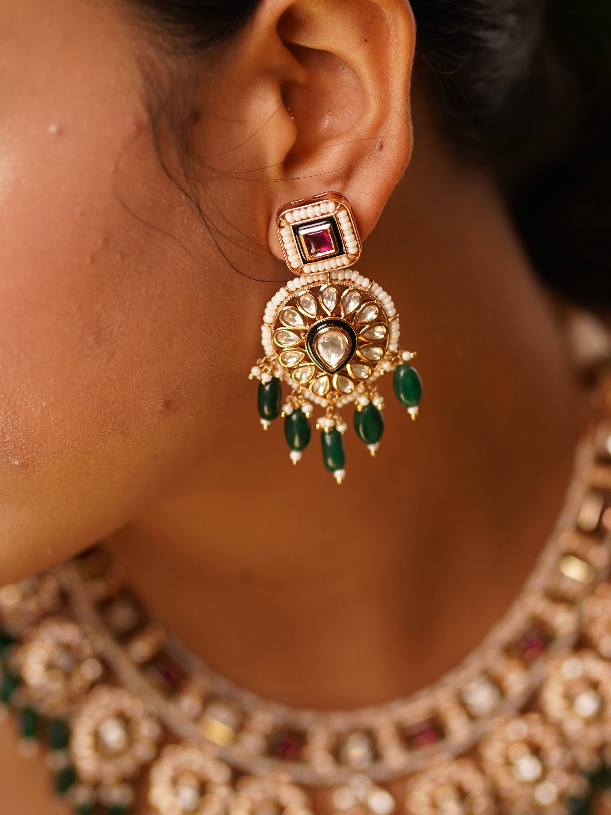 Side angle of kundan necklace featuring symmetrical emerald beads and golden frame