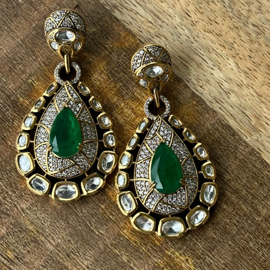 Close-up of intricate vintage-inspired earrings with sparkling center stone