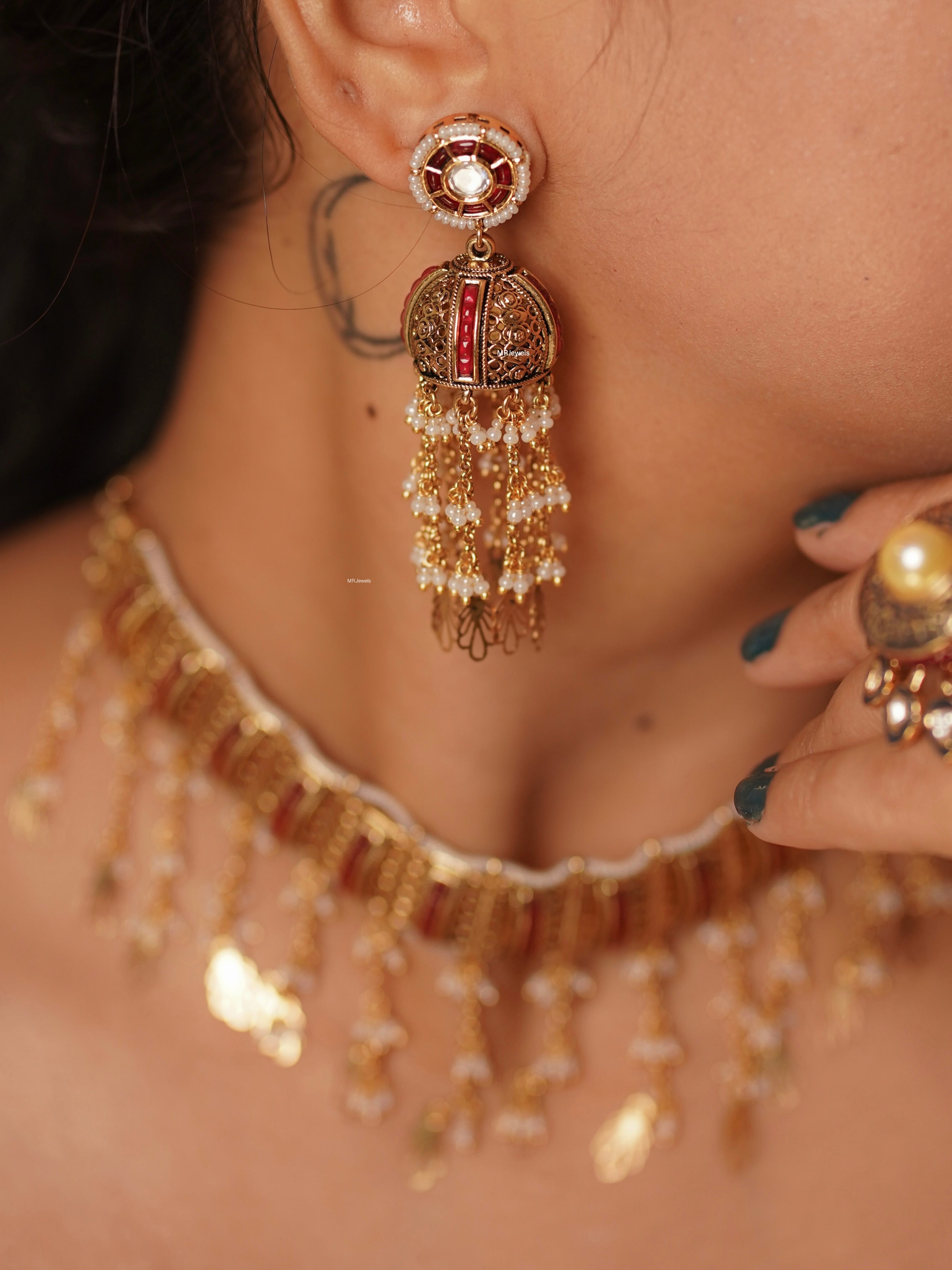 Close-up of Mughal-inspired choker necklace with gold-plated finish and jhumki earrings