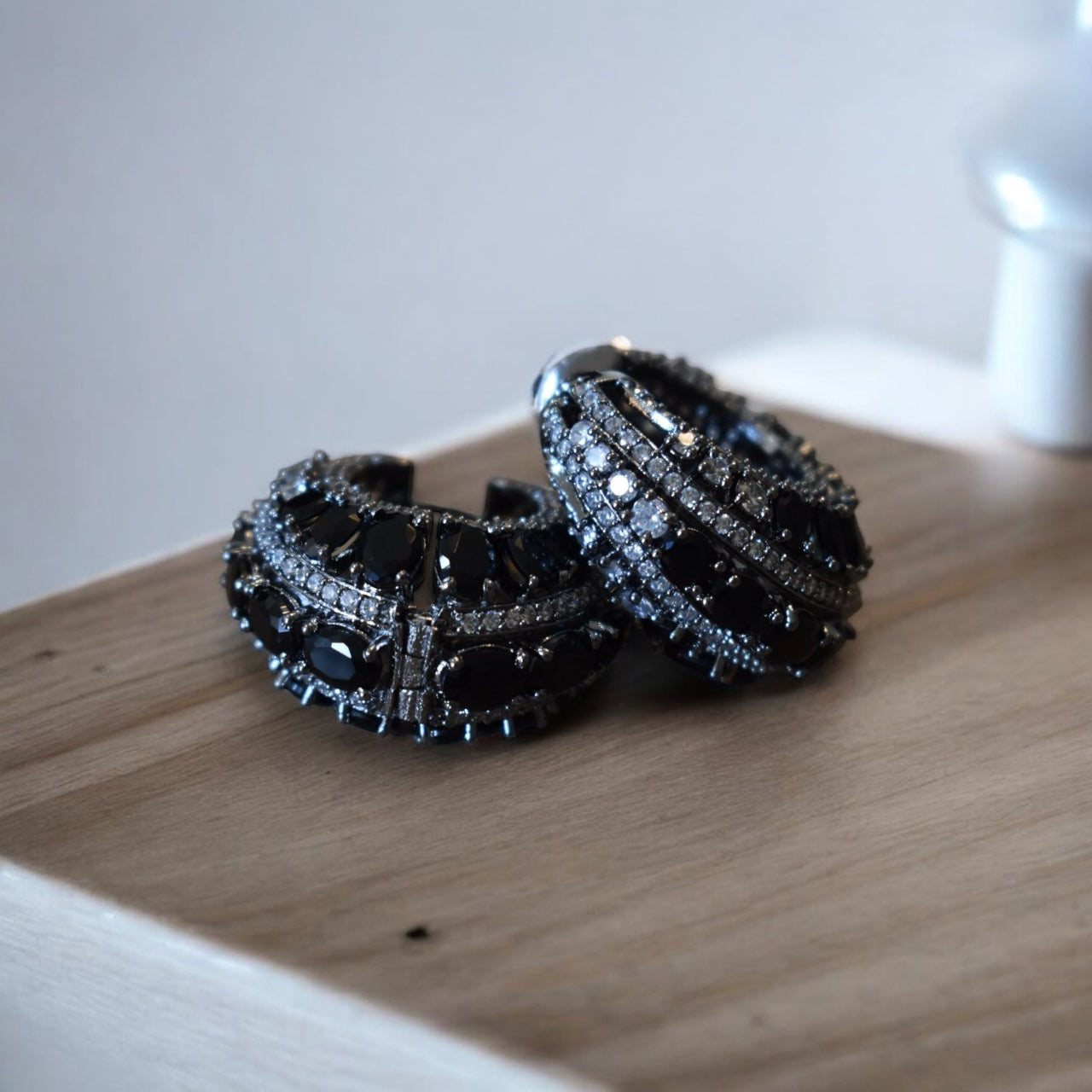 Angled detail of textured victorian hoops with symmetrical metal pattern