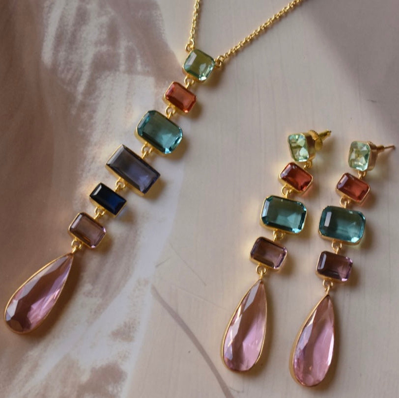 Front view of gemstone necklace and earring set with multicolored faceted stones
