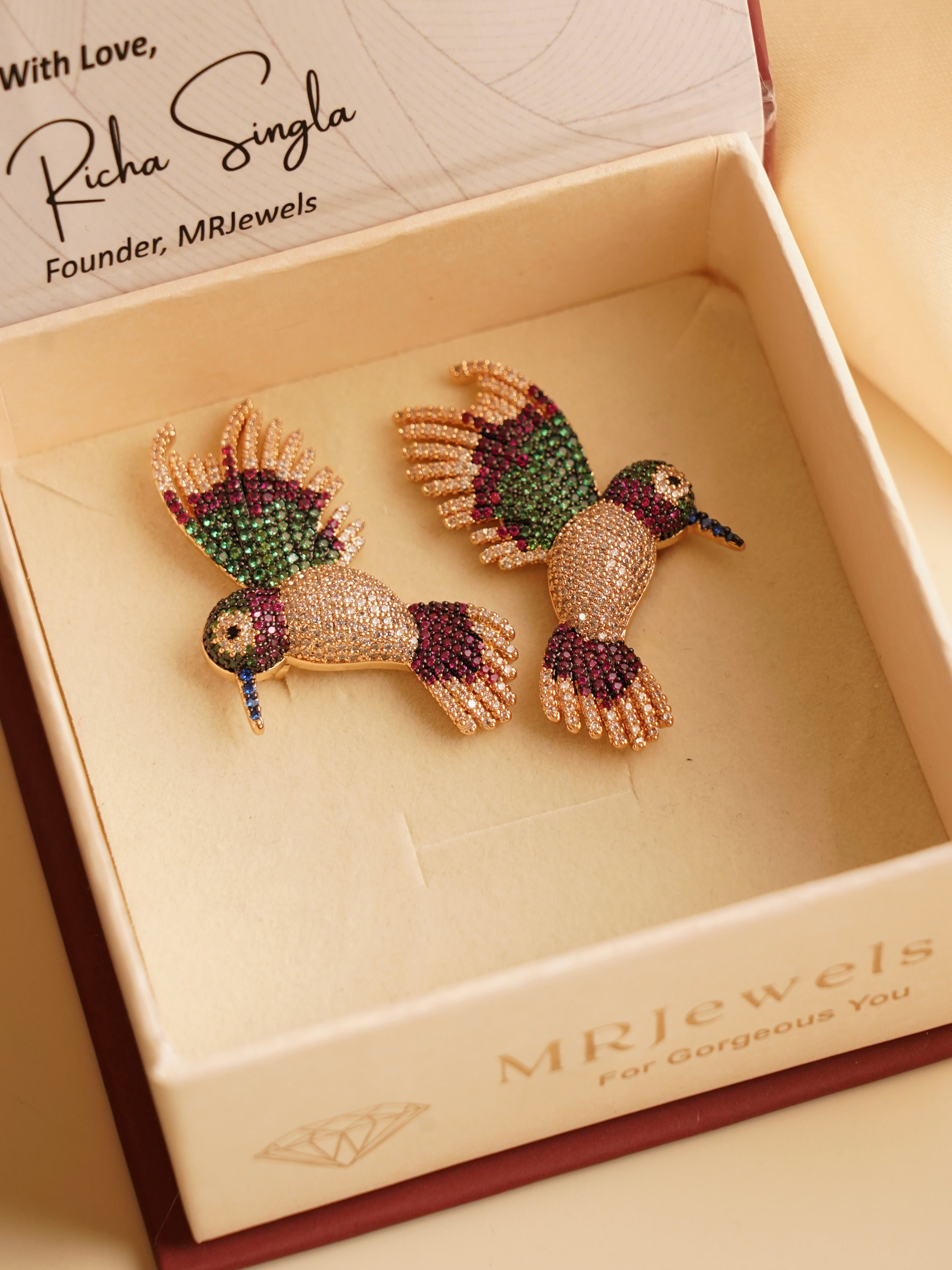 Side view showing slim rhodium earring profile with polished finish