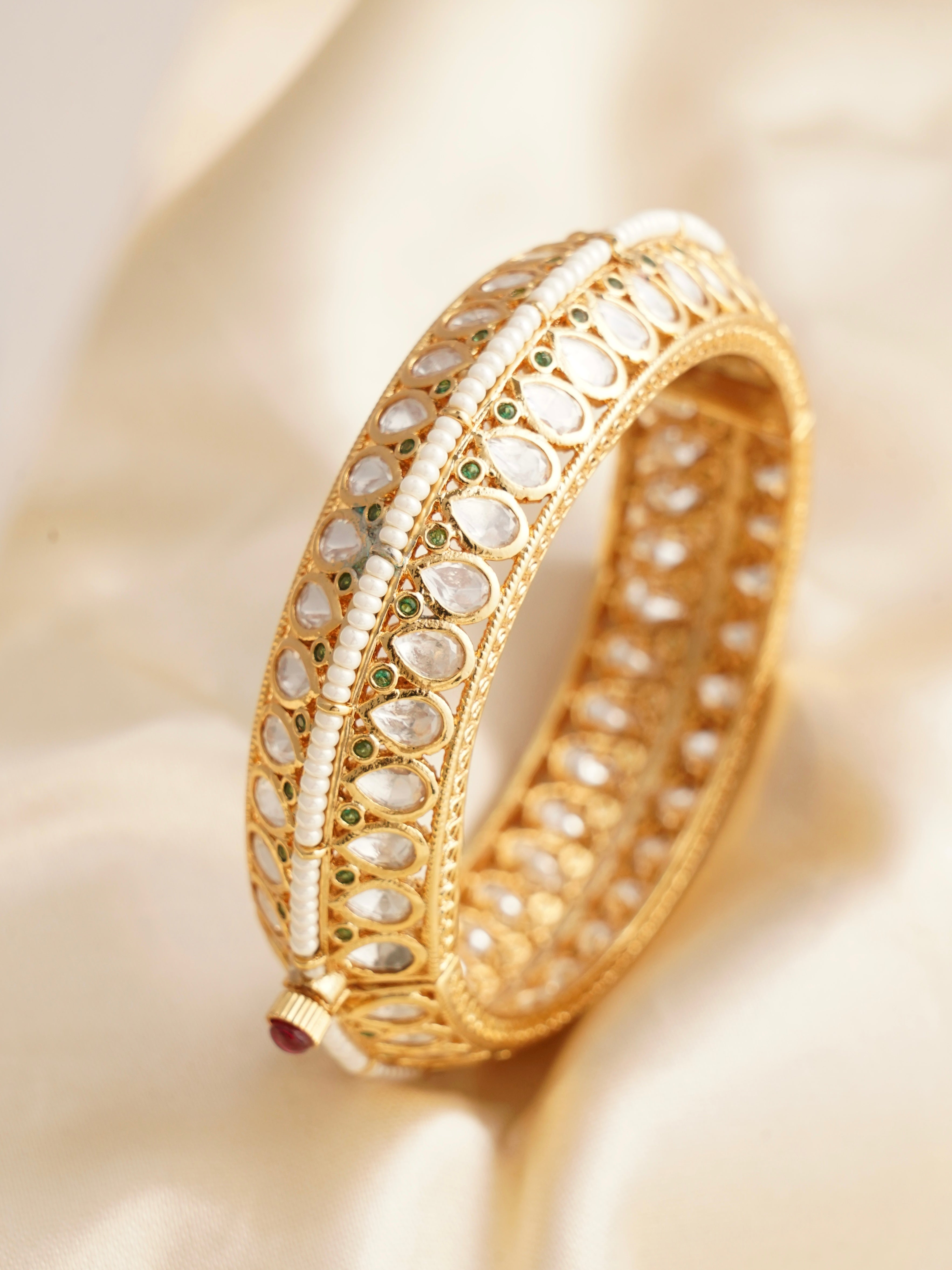 Openable kundan kada with jadau work, pearl border, and green meenakari highlights