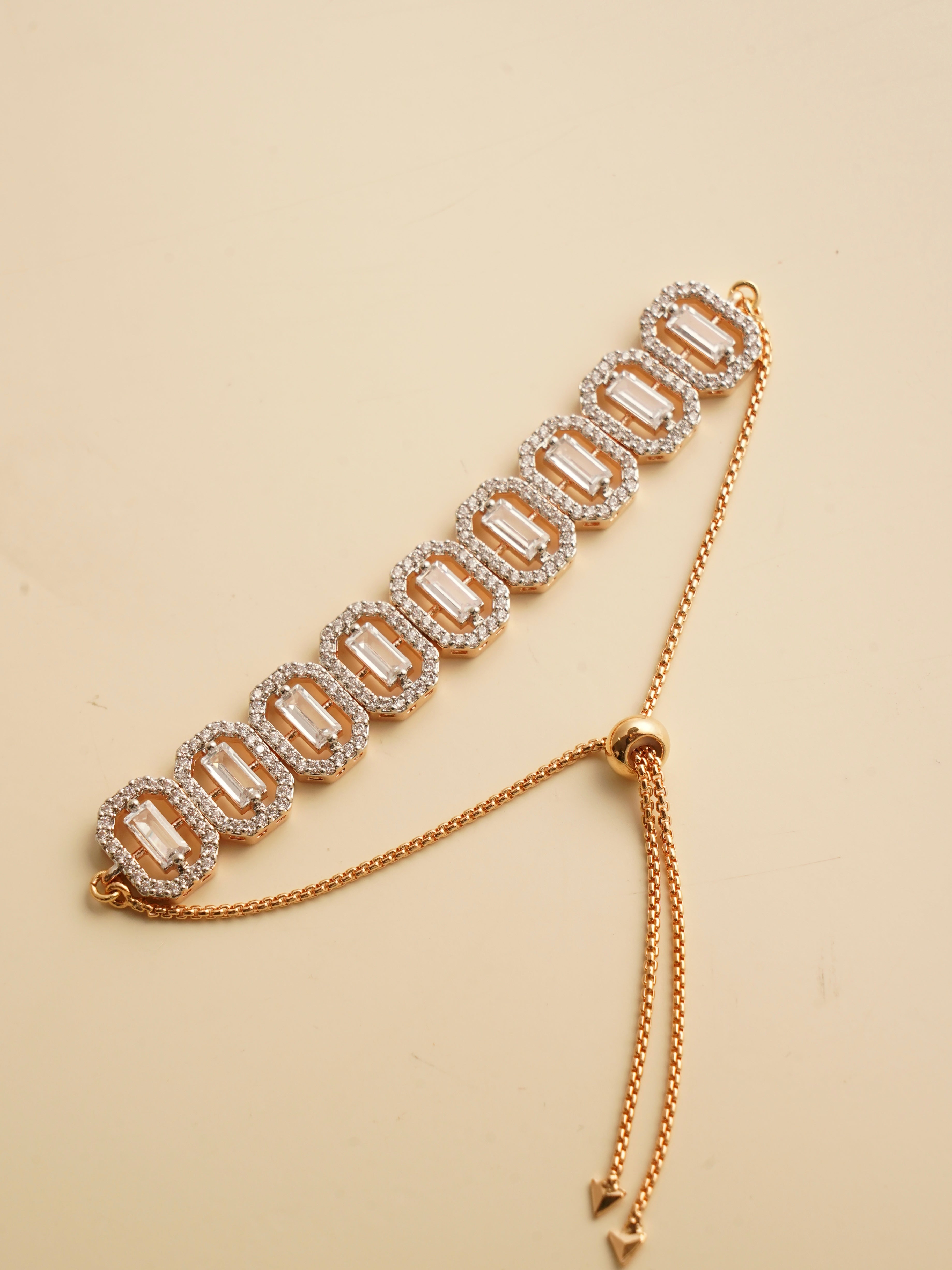 Rose gold adjustable bracelet with baguette stones and zircon halo links arranged in a geometric pattern