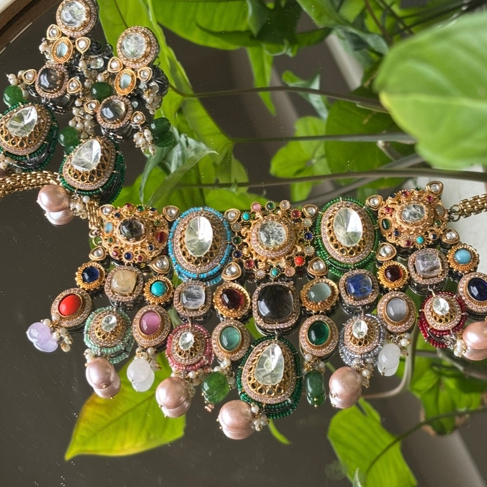 Angled shot of Zayra choker with matching drop earrings and antique gold finish