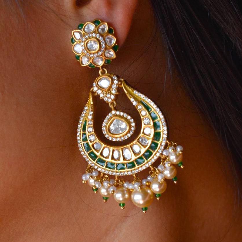 Gold-plated crescent-shaped kundan earrings with green drop detailing