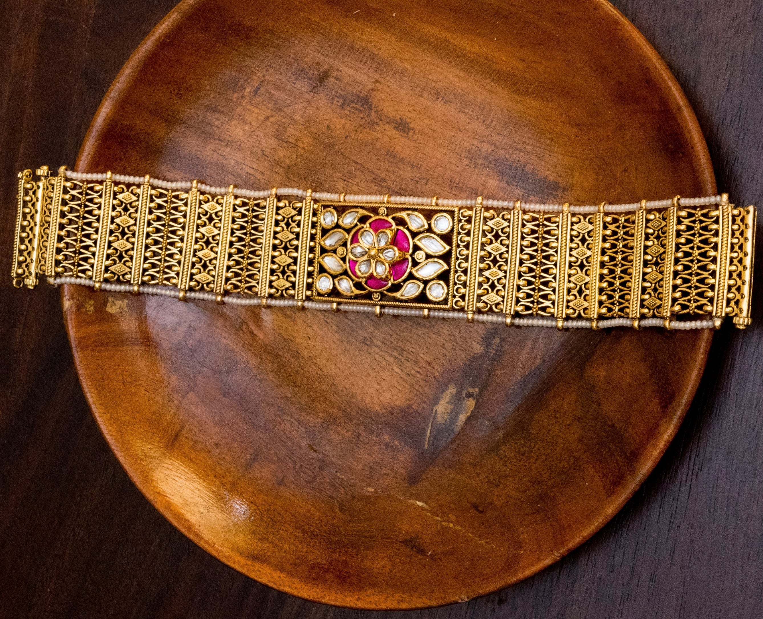 Close-up of traditional vilandi kundan bracelet with floral motif and chandan har concept