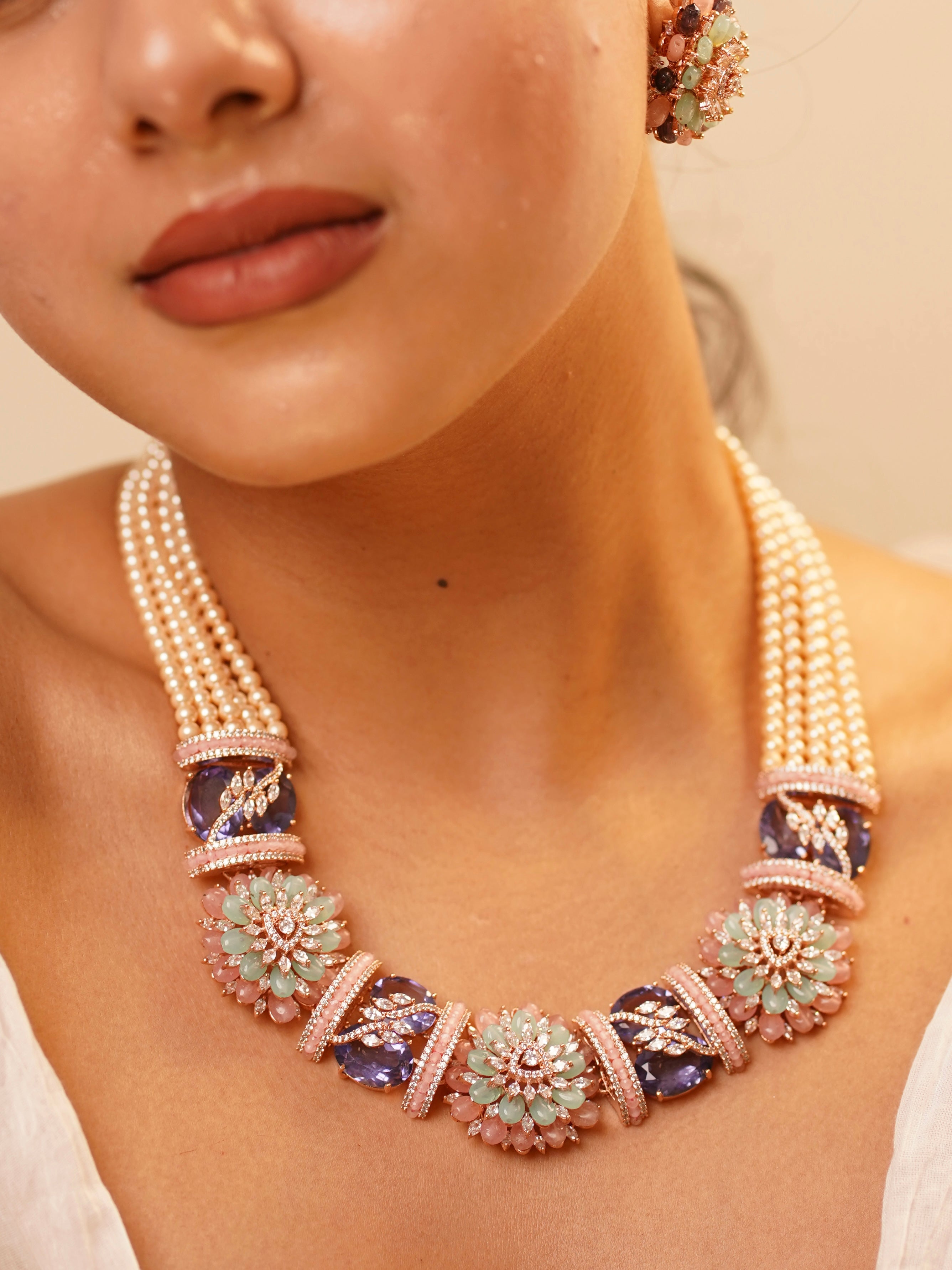 close-up of layered pearl and diamond-look beaded necklace set with matching earrings