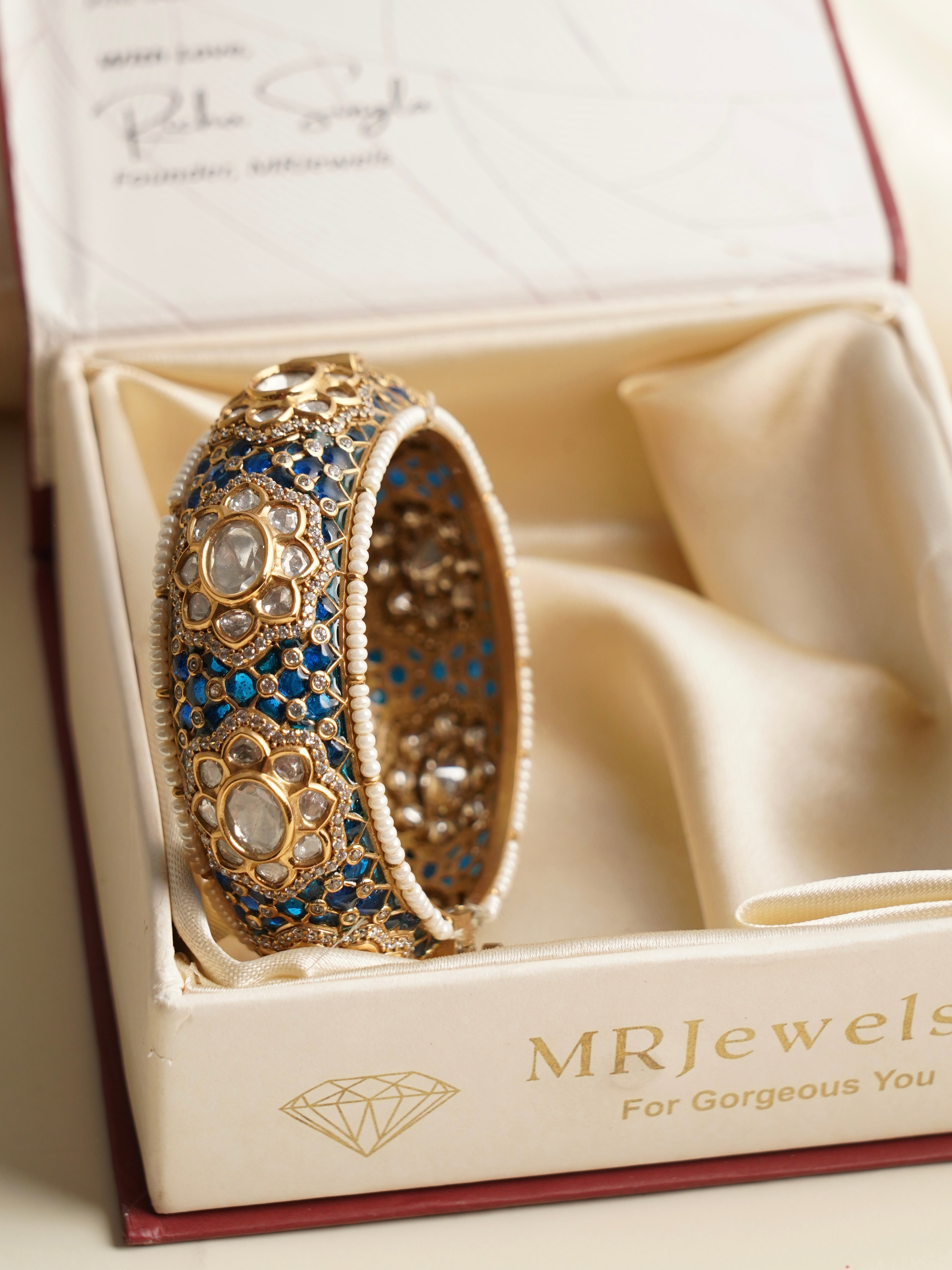 top view of meenakari kada featuring kundan polki design in gold finish