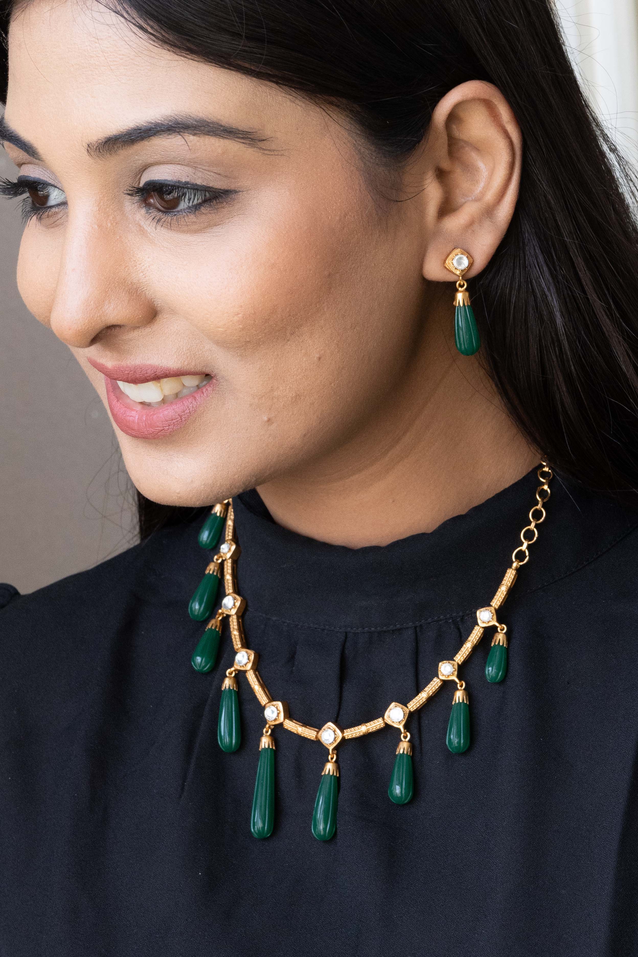 Angled necklace shot highlighting centerpiece design and matching stonework