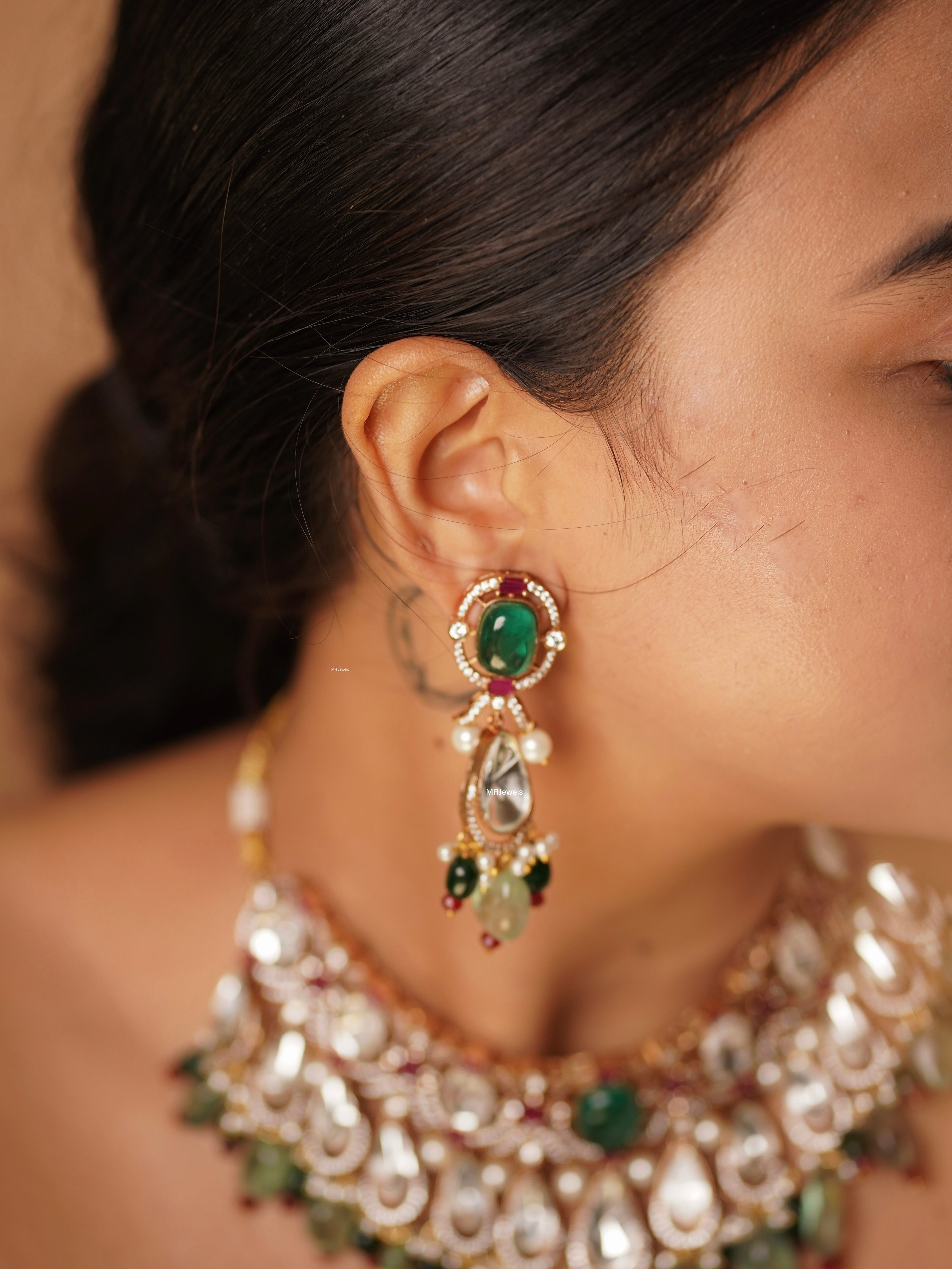 Angled view of gemstone necklace with rich kundan detailing and colourful stone accents