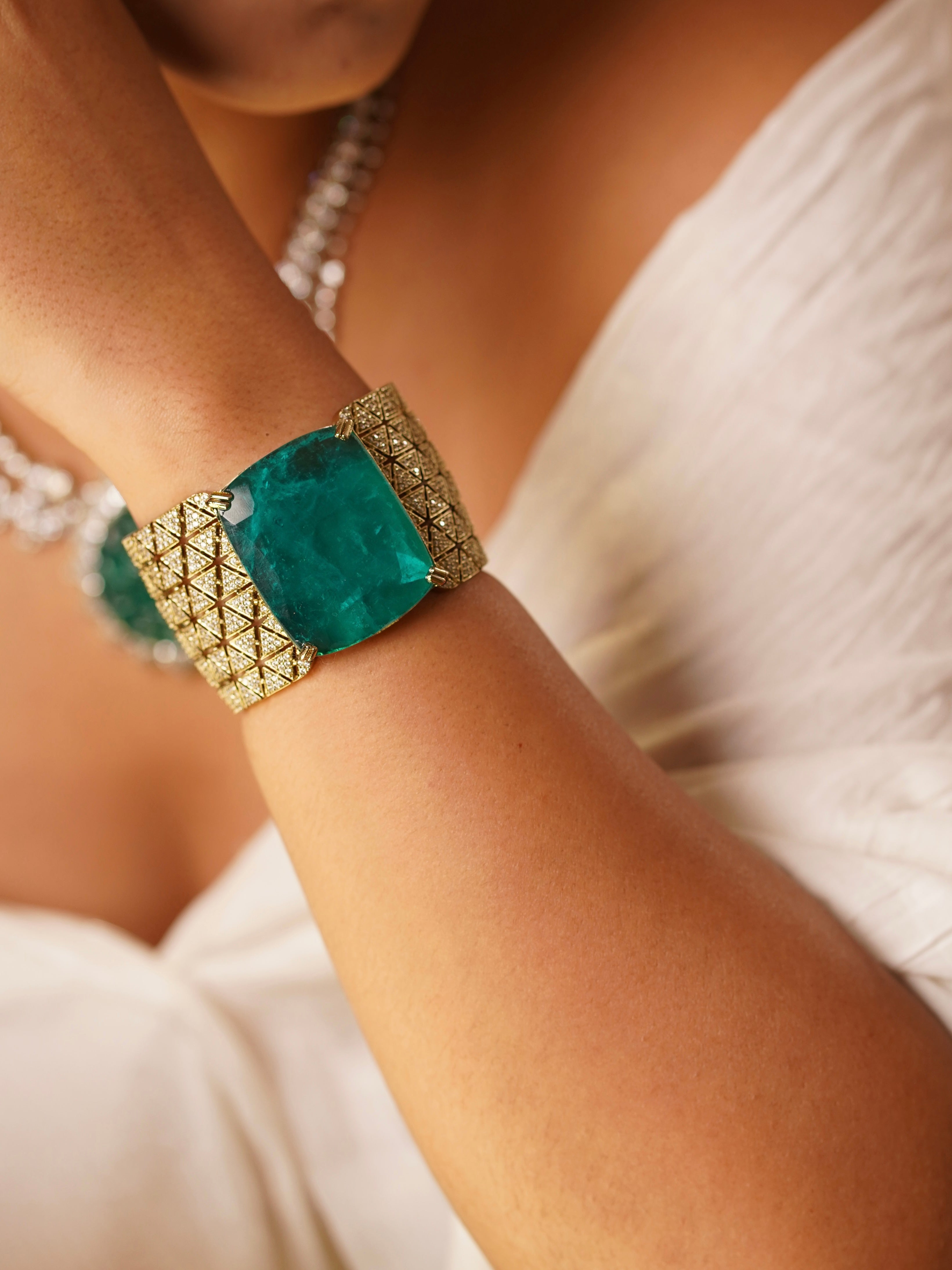 Gemstone cuff bracelet with diamond-cut latticework and openable hinge design