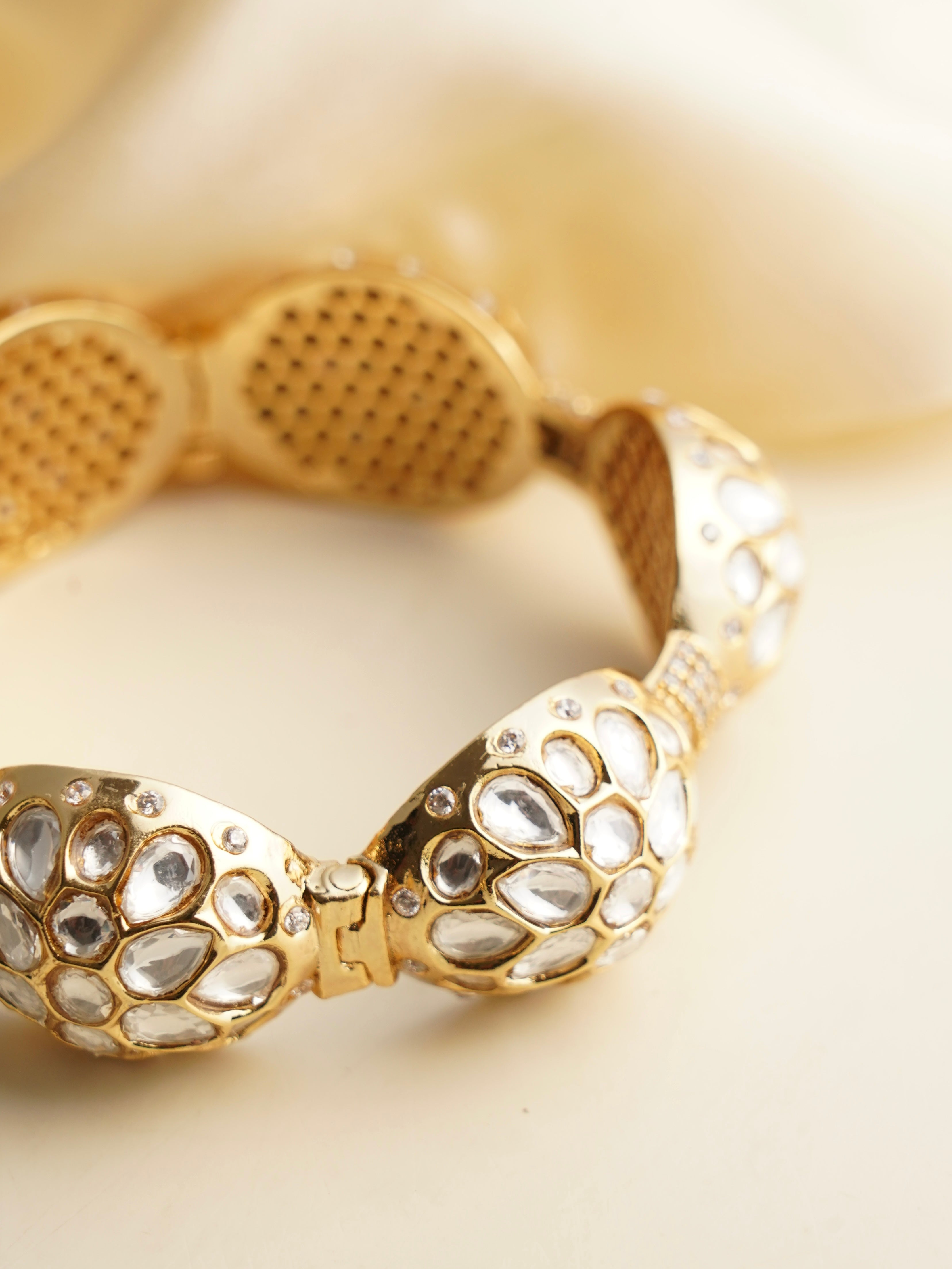 Close-up side view of openable kundan kada with dome setting