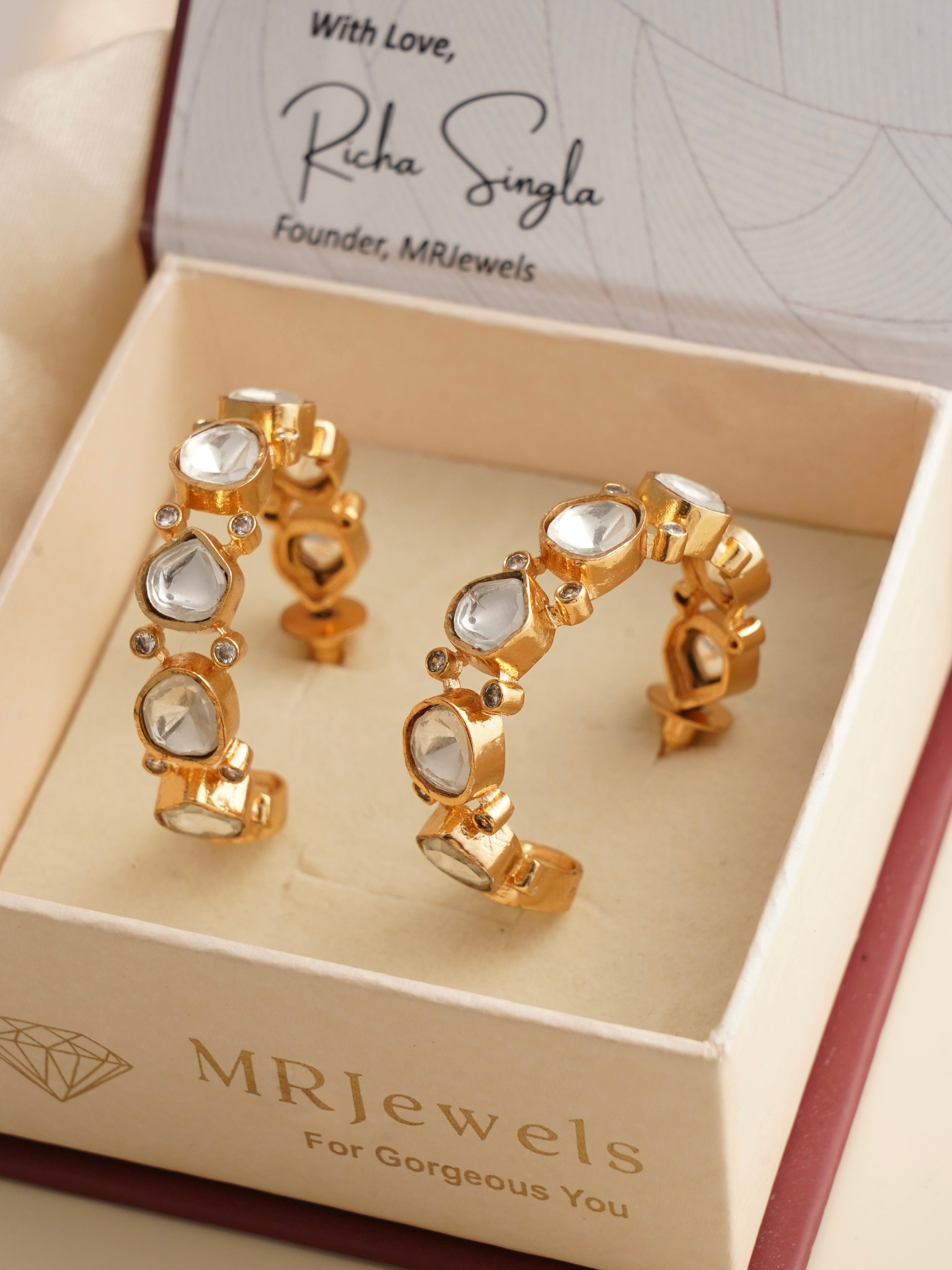 Gold-plated kundan hoop earrings with ruby centre and floral drops