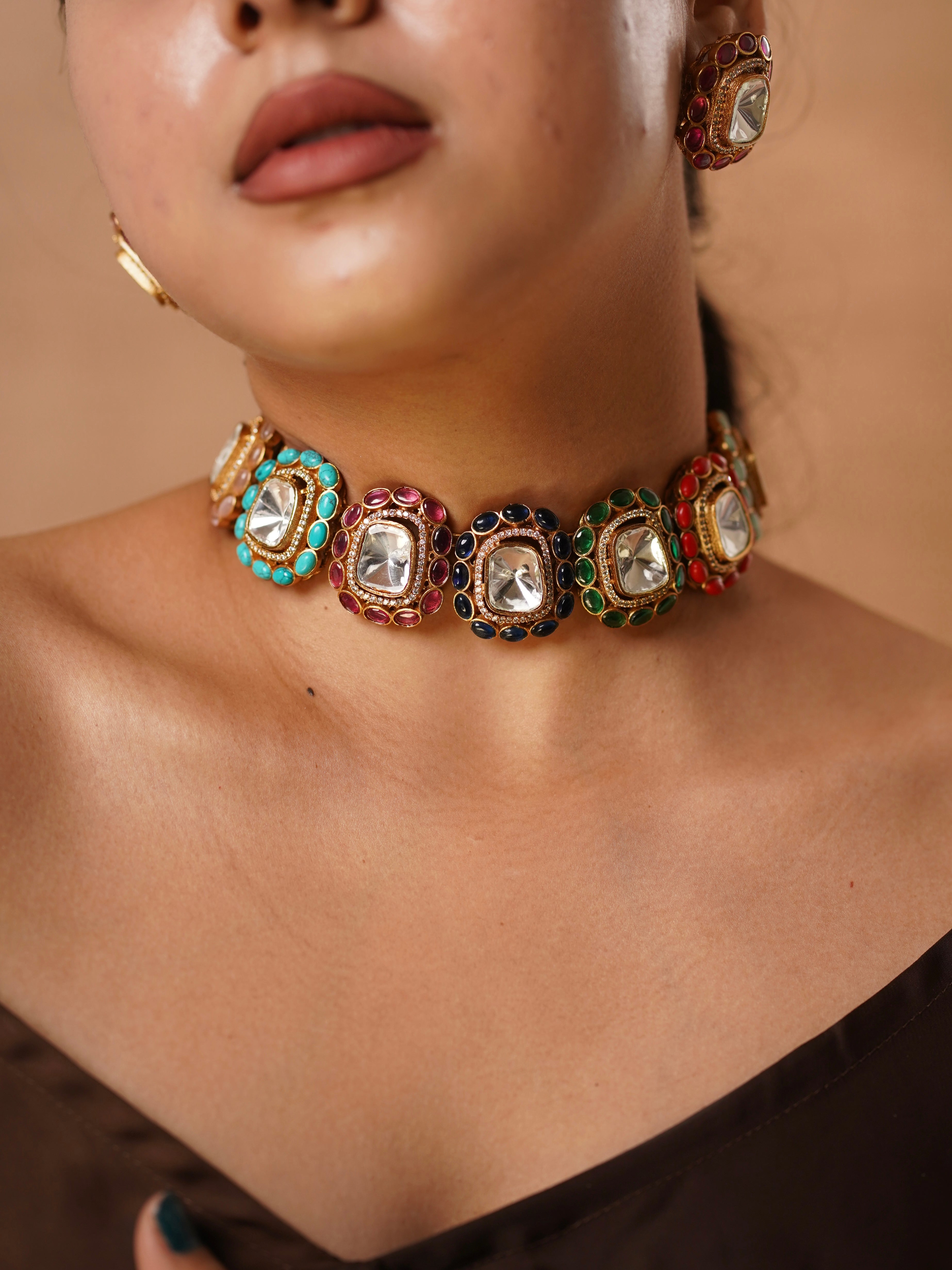 Multicolor gemstone choker with kundan work and mirrored centerpiece, paired with stud earrings