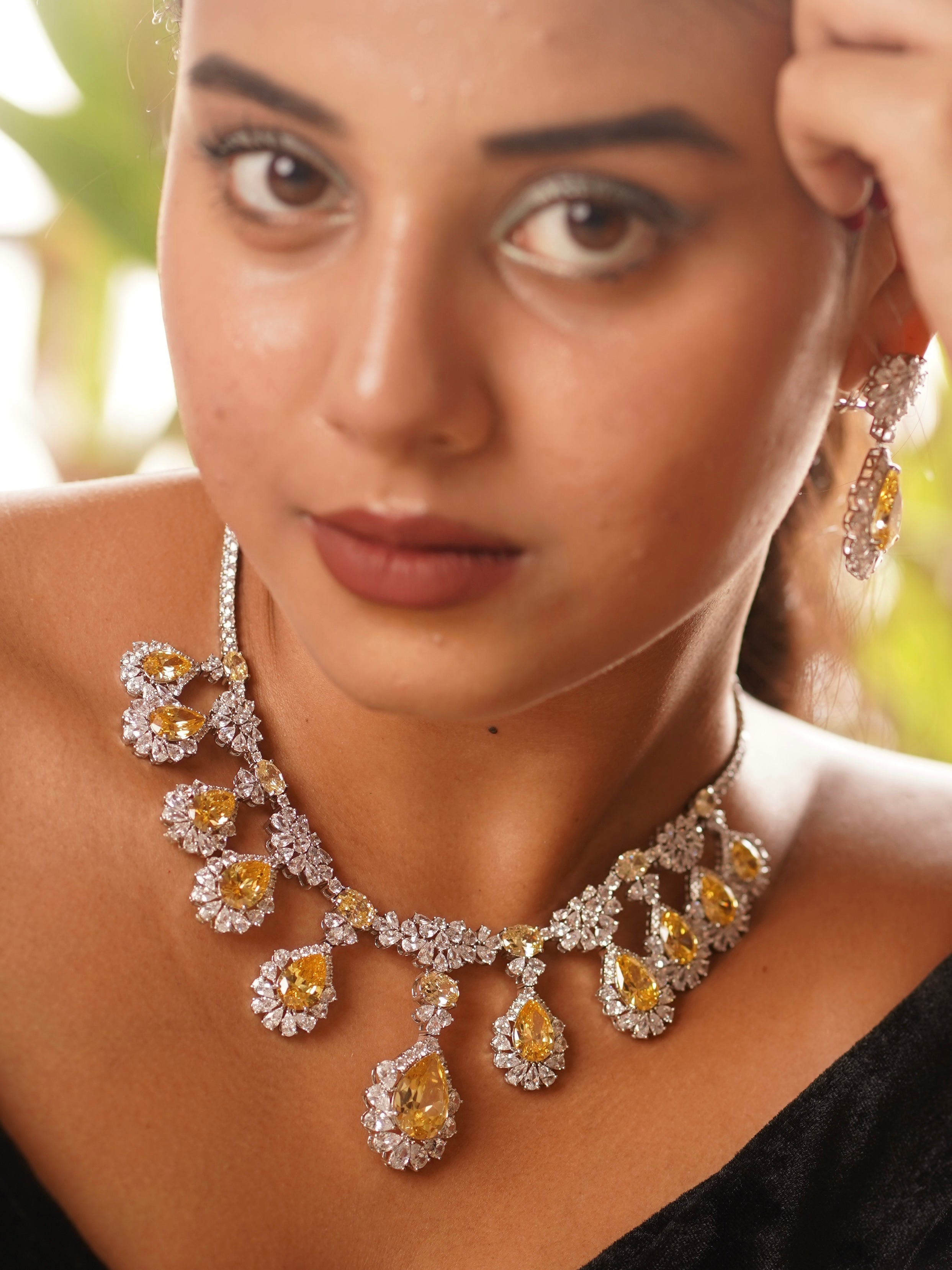 Close-up of citrine drop diamond necklace set with teardrop pendant and delicate stone detailing