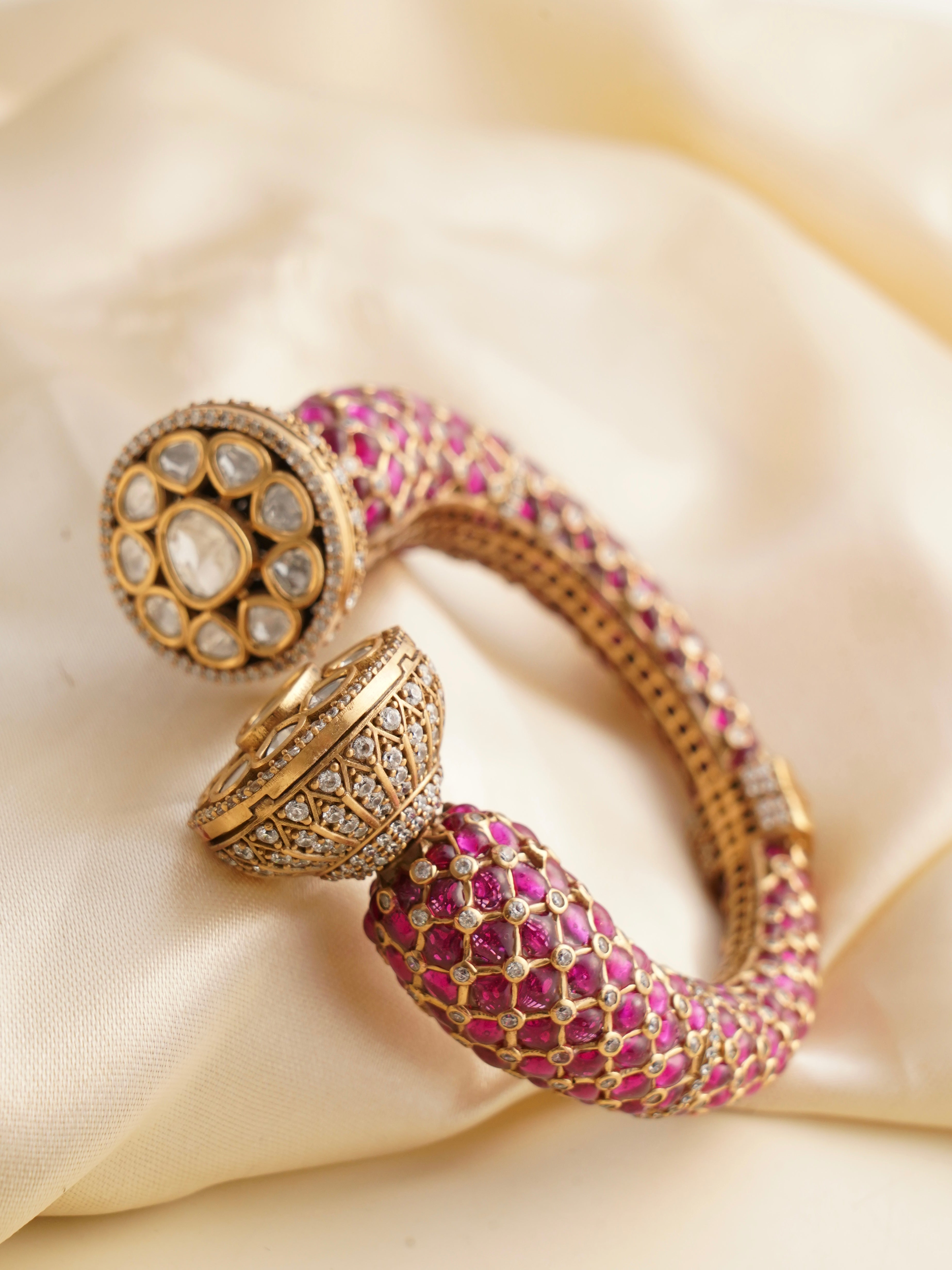 Kada clasp view highlighting green meenakari and delicate stone embellishments