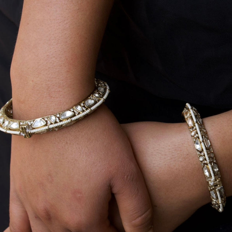 Angled view of elegant polki bangles with traditional stonework and fine design