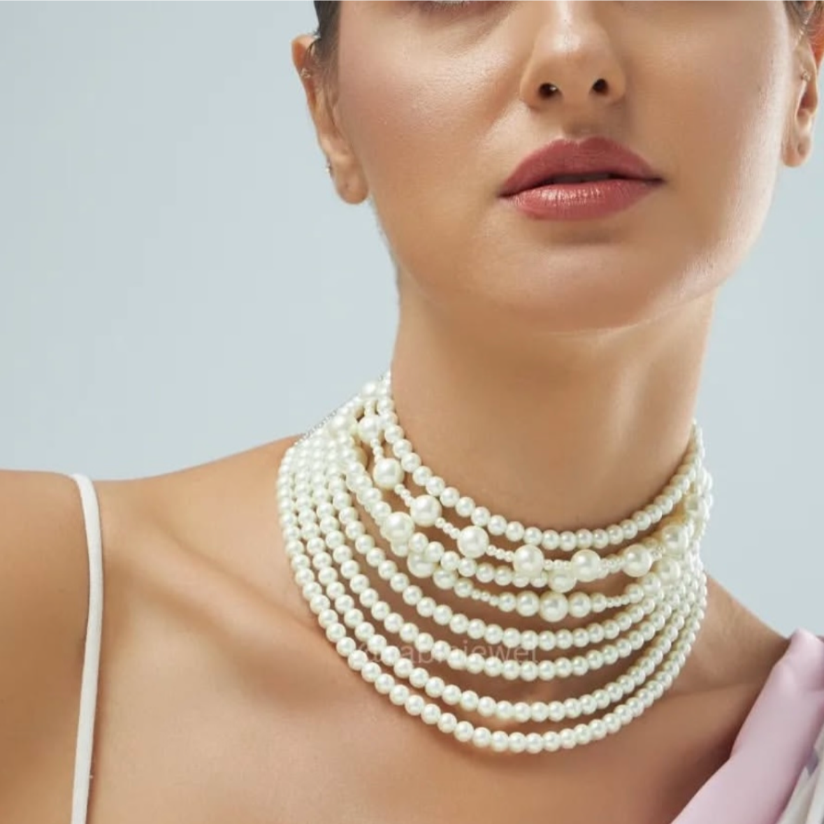 Side angle of layered pearl necklace showcasing elegant curve and sheen