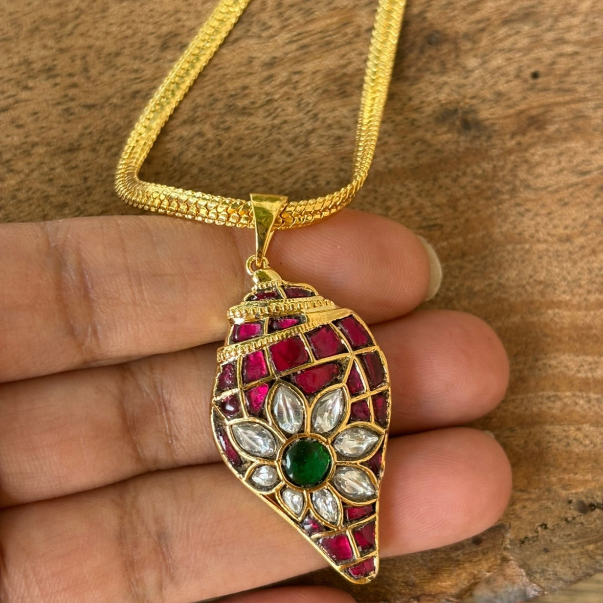 Angled close-up of kundan pendant with elegant silhouette and traditional detailing