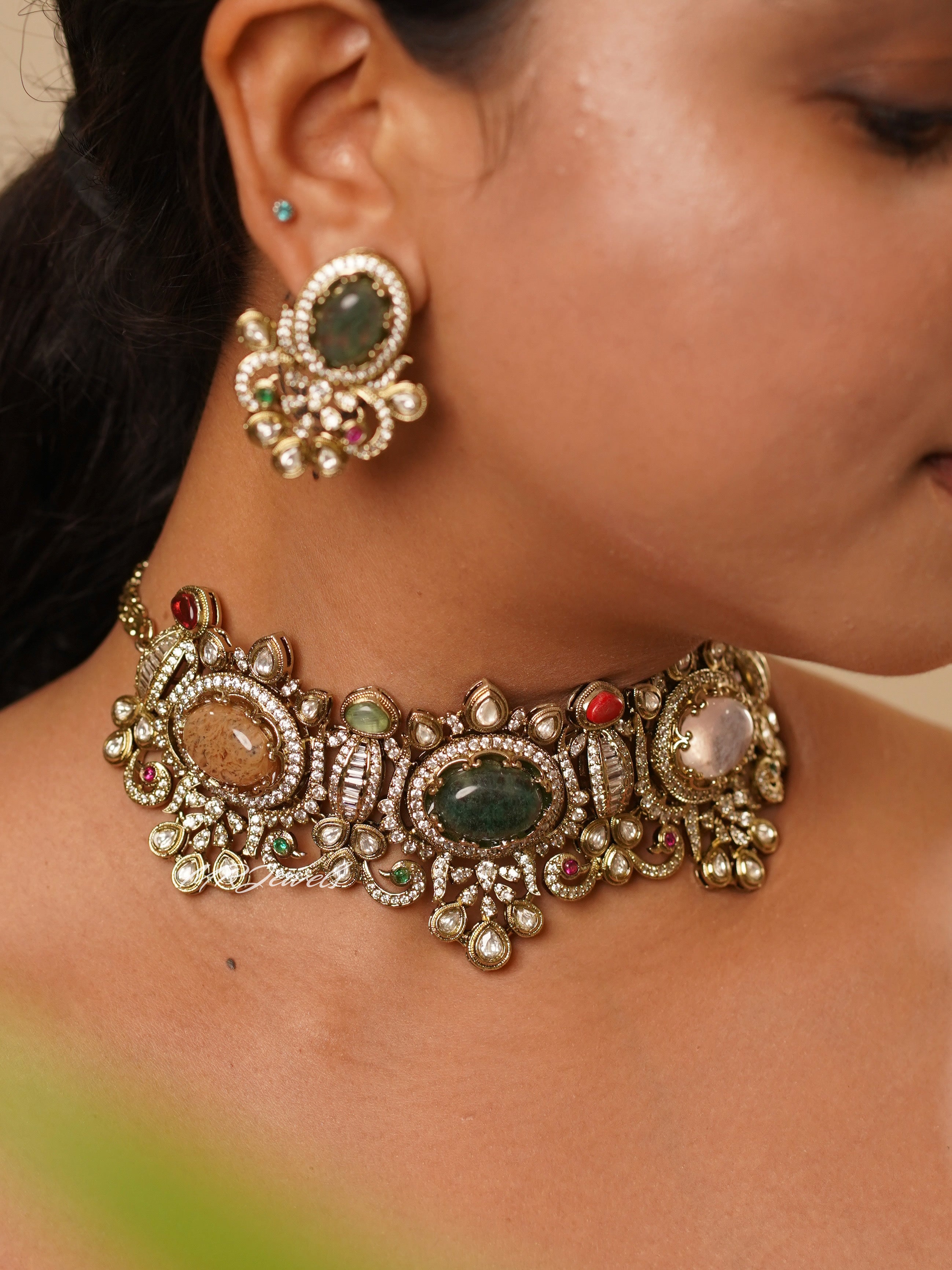 Front view of riwaayat choker set with carved multicoloured stones and antique gold floral detailing