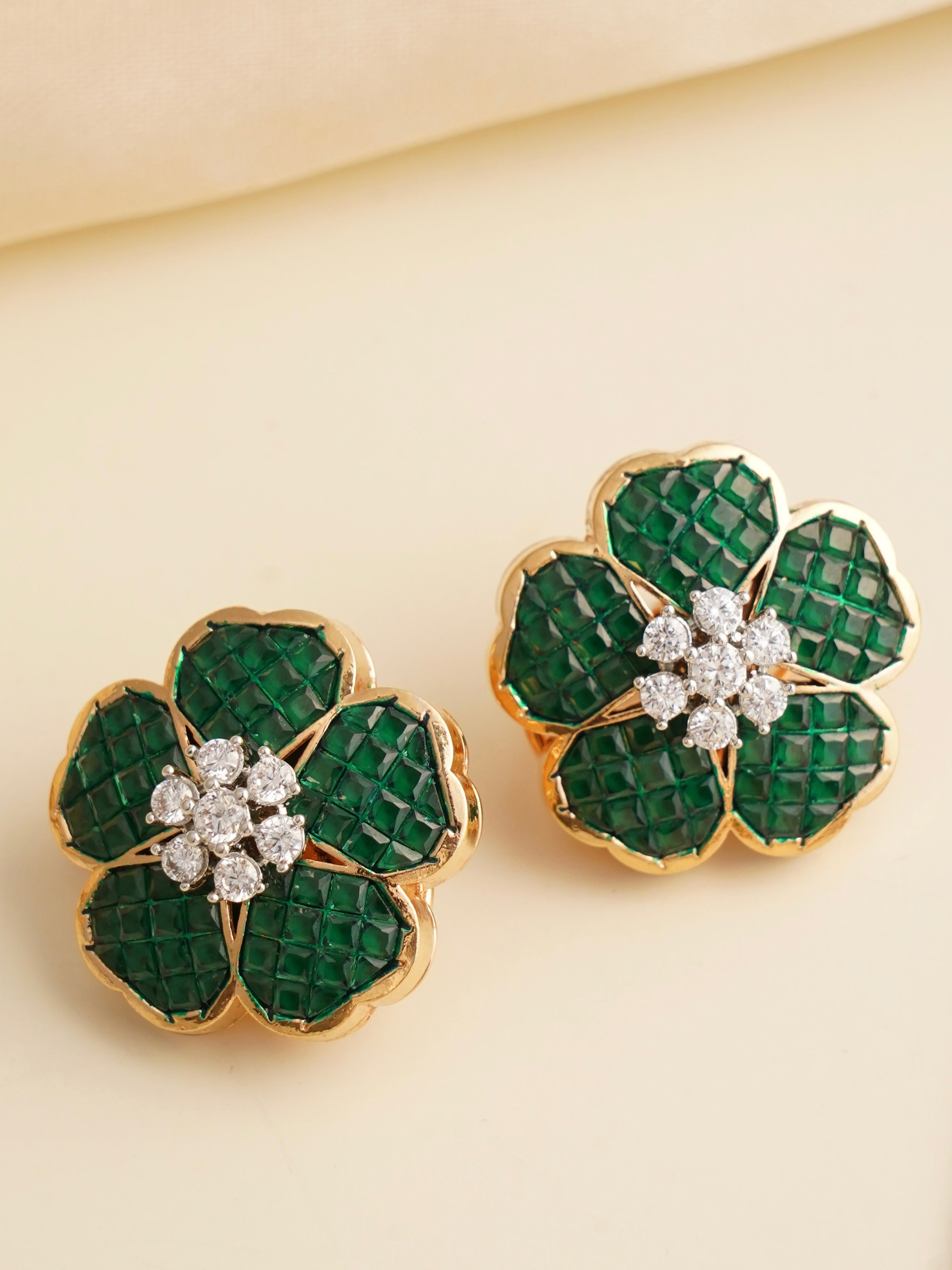 Gold-plated ring from emerald set with green petal design and CZ cluster