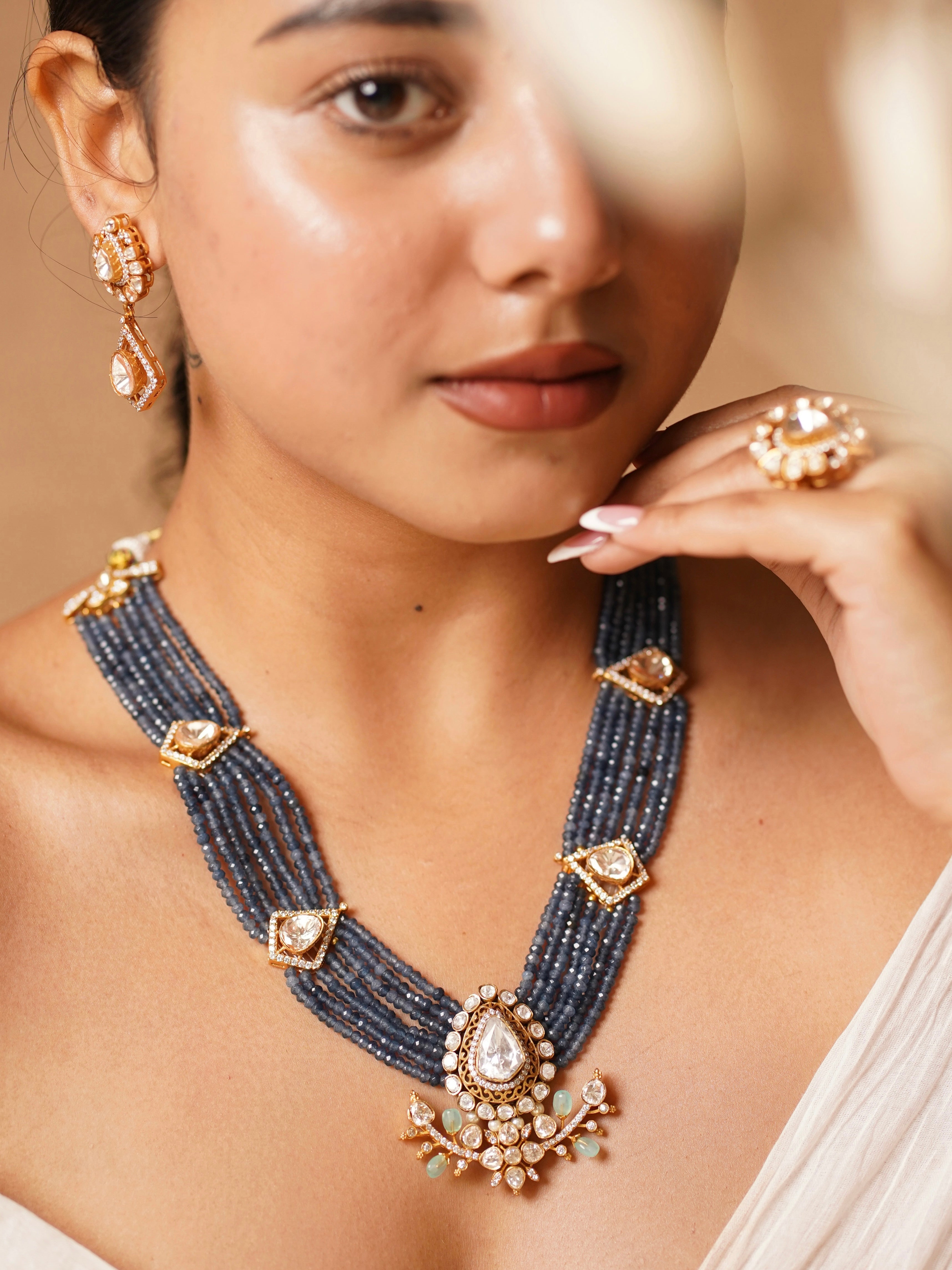 Side view of riyasat necklace showing pearl fringe and lotus details