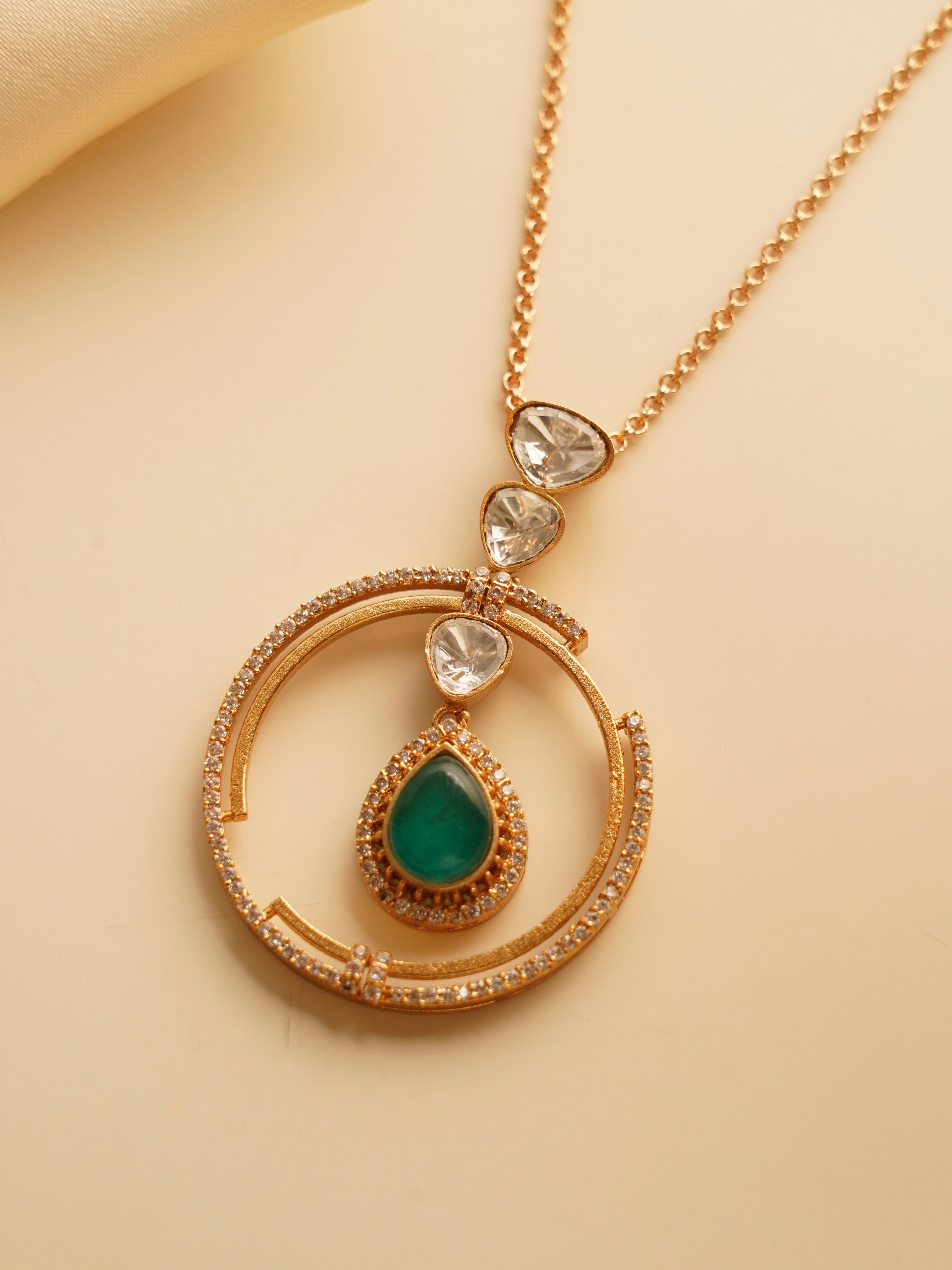 Matching drop earrings with emerald teardrop and kundan accents from Ziva Circle Drop Set