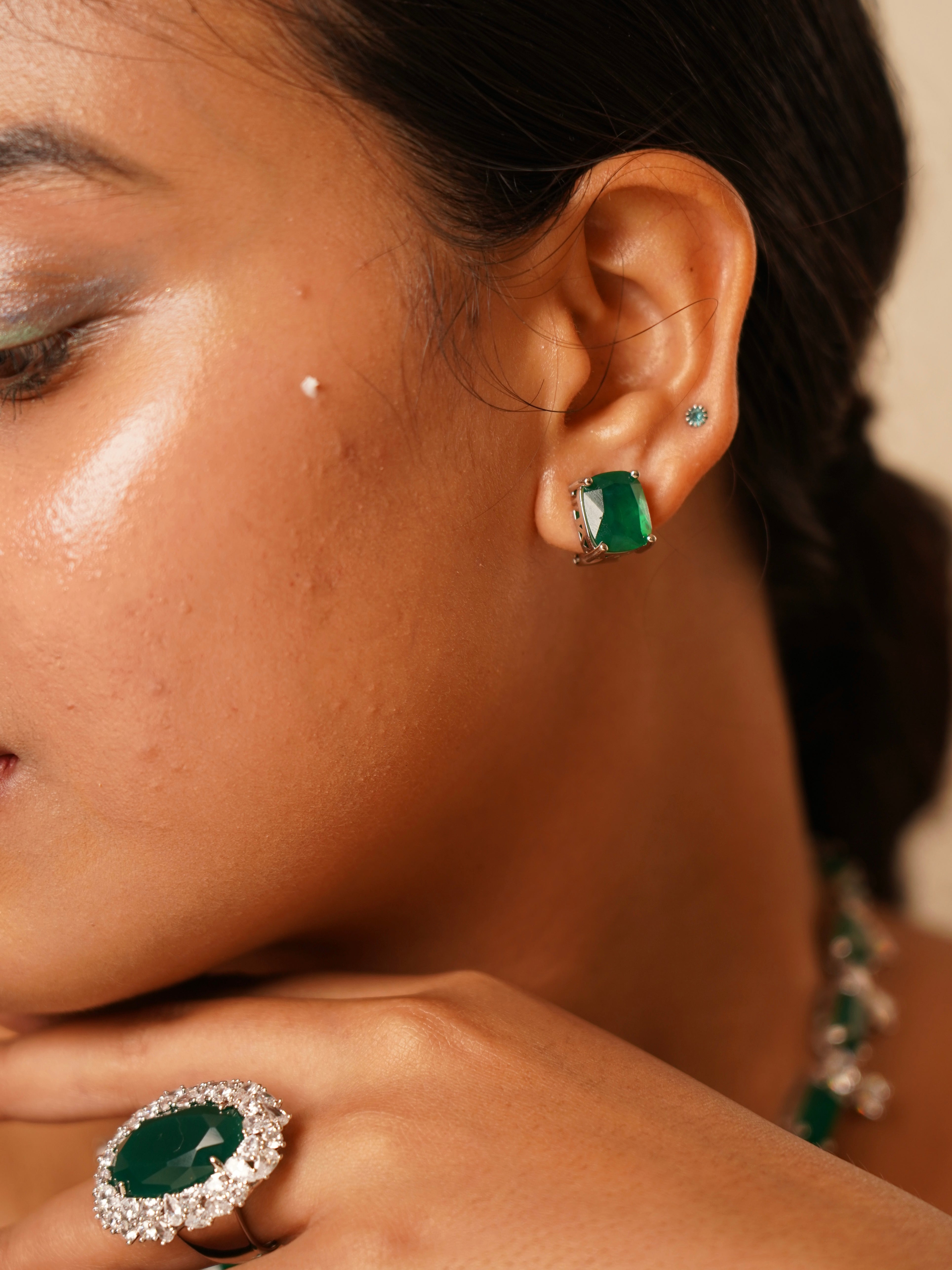 Side view of Ziva Emerald Envy necklace showing stone detailing and coordinated stud earrings