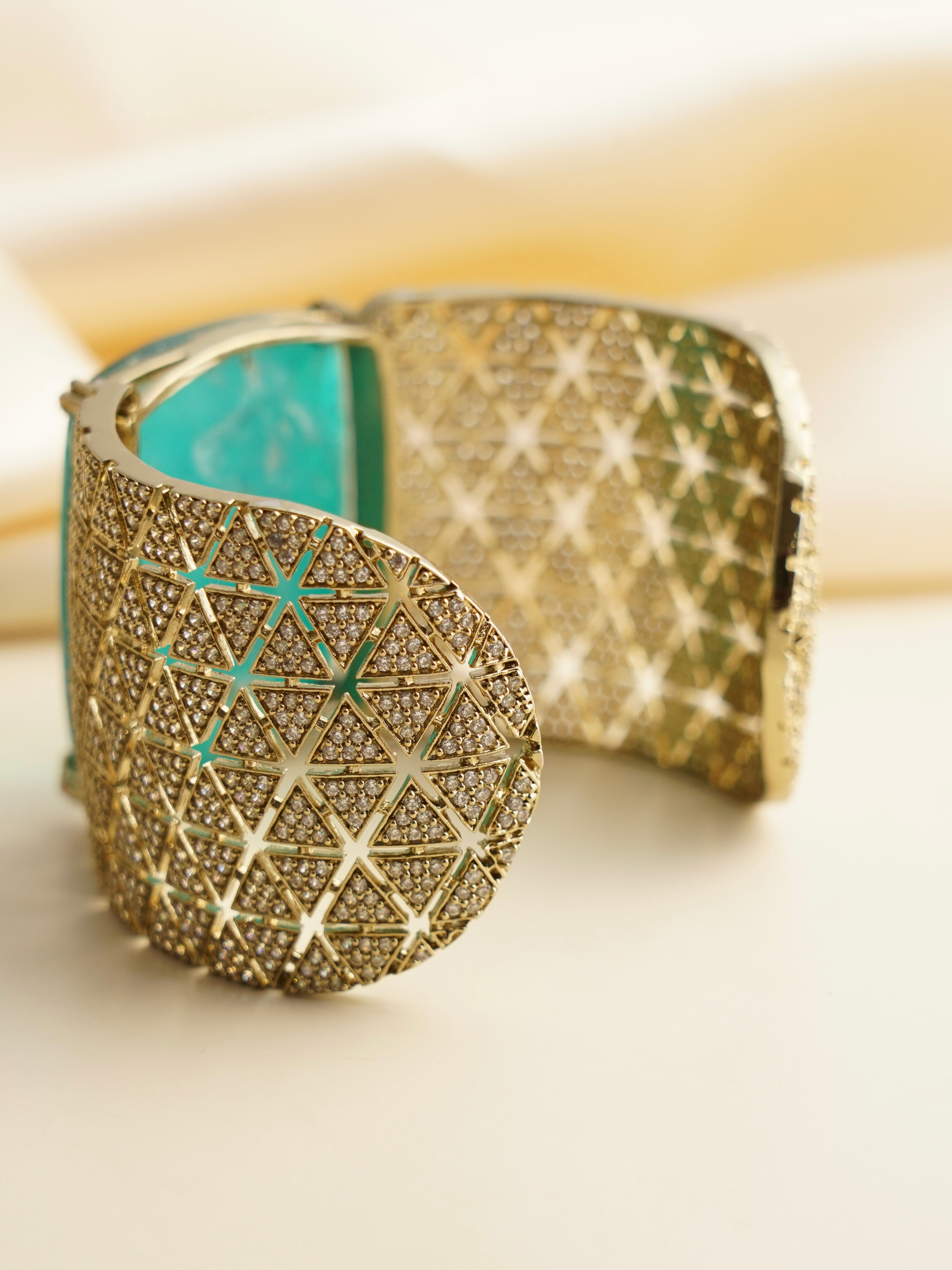 Side profile of gemstone statement cuff bracelet with radiant openwork design