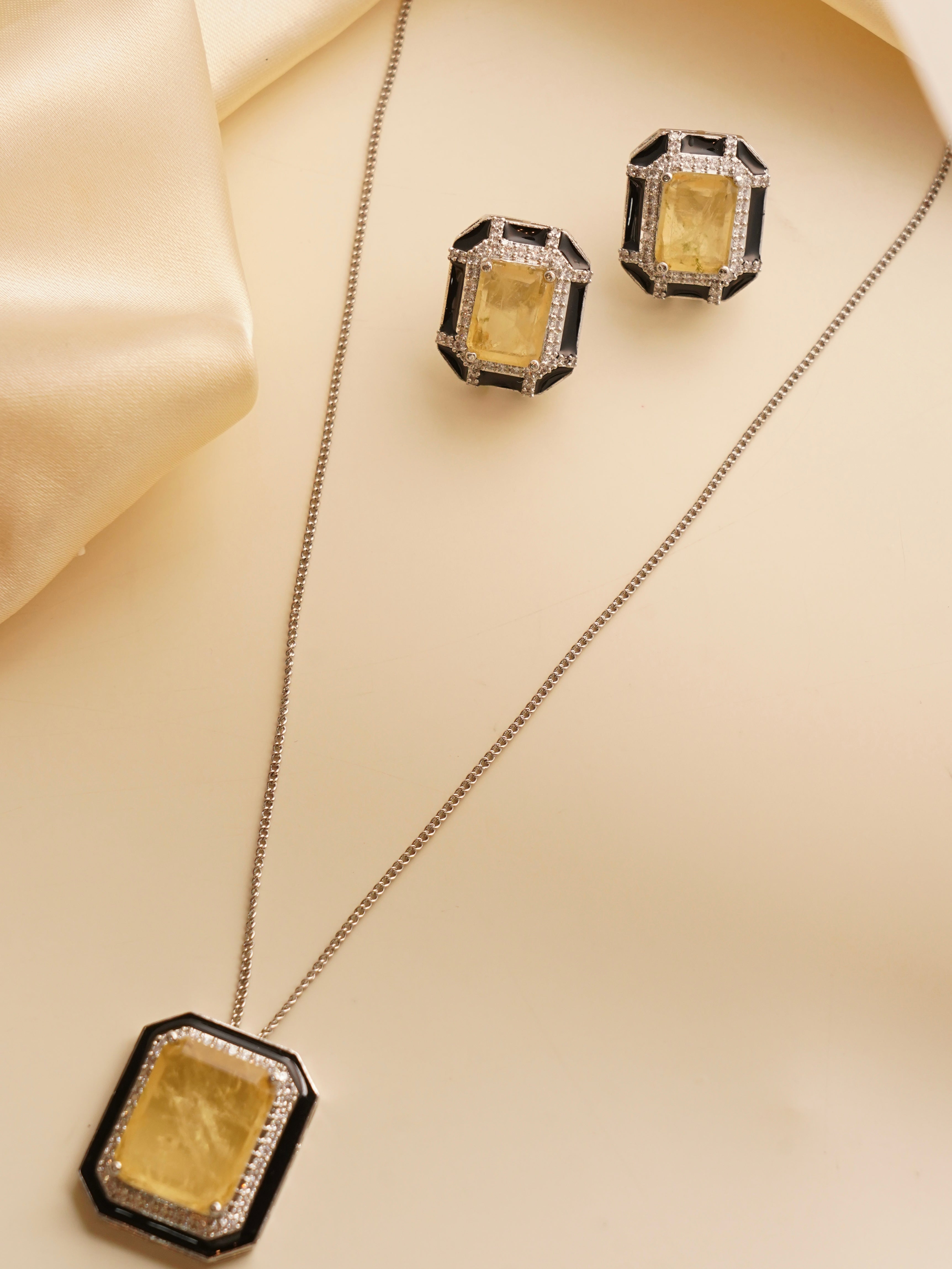 Statement necklace and earring set with citrine stones, black enamel and zircon accents in geometric design