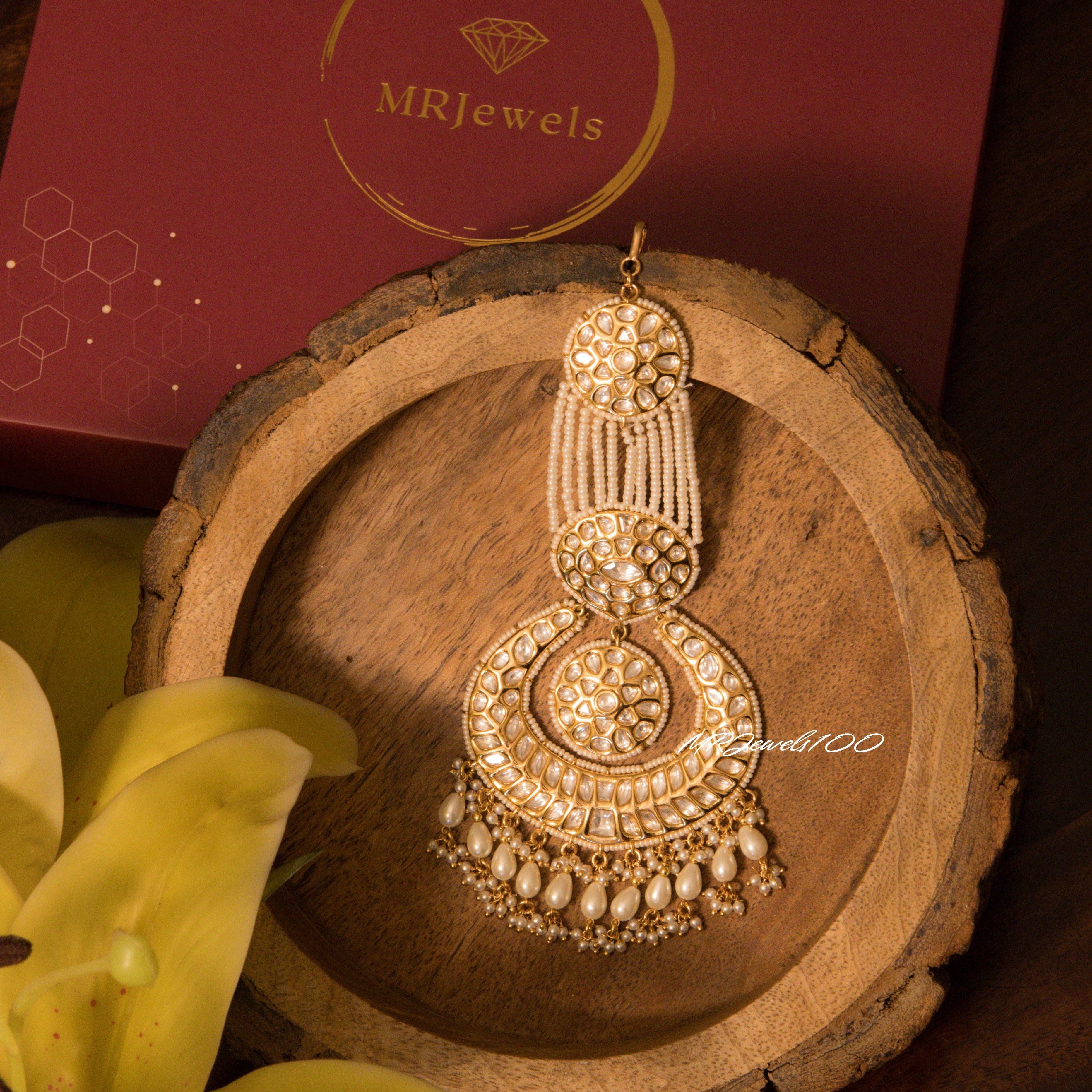 Front view of Mughal-style kundan passa featuring teardrop pearls and stone clusters