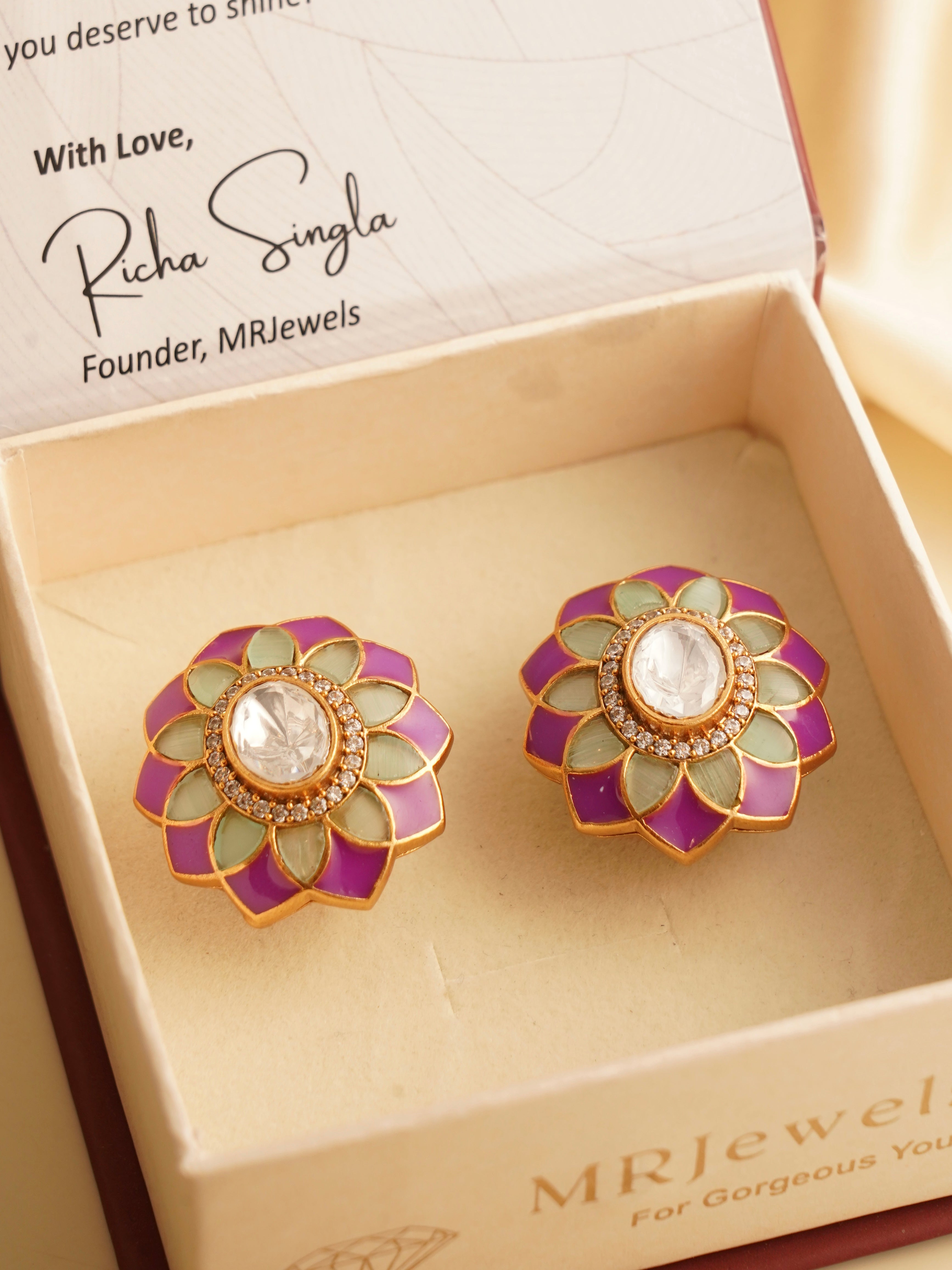 Polki flower studs with purple and sage green enamel petals and central stone, displayed in box